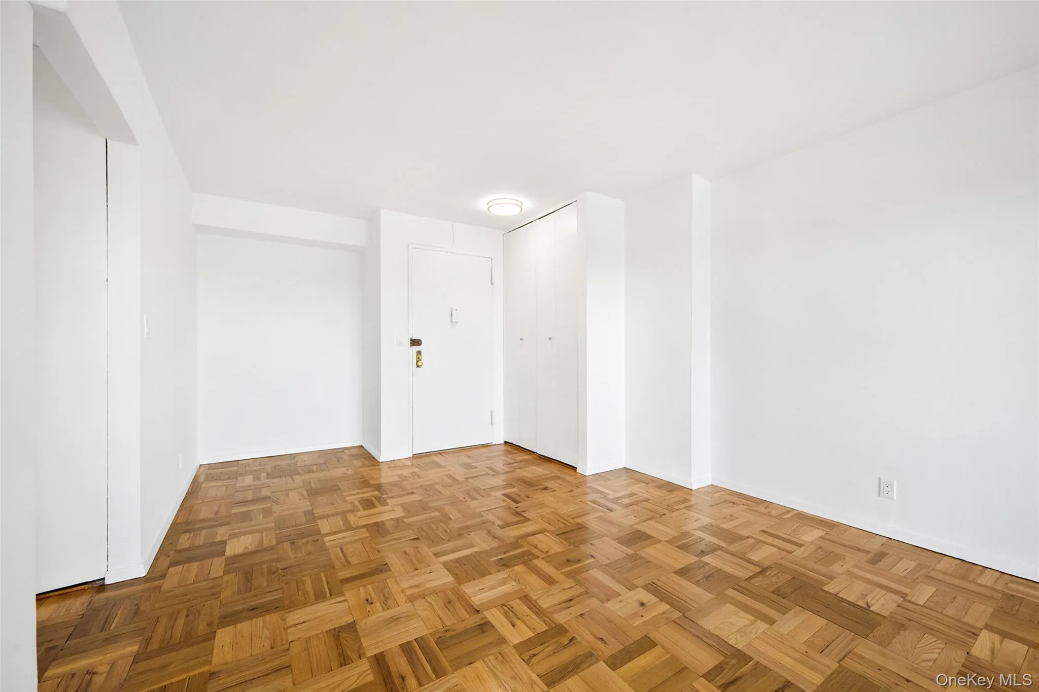 Parquet wood-finish flooring complements the bright white walls and ceiling Parquet wood-finish flooring complements the bright white walls and ceiling
