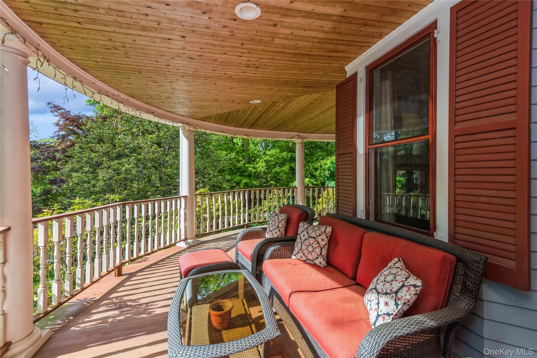 Wraparound, mahogany wood porch, featuring outdoor hangout area Wraparound, mahogany wood porch, featuring outdoor hangout area