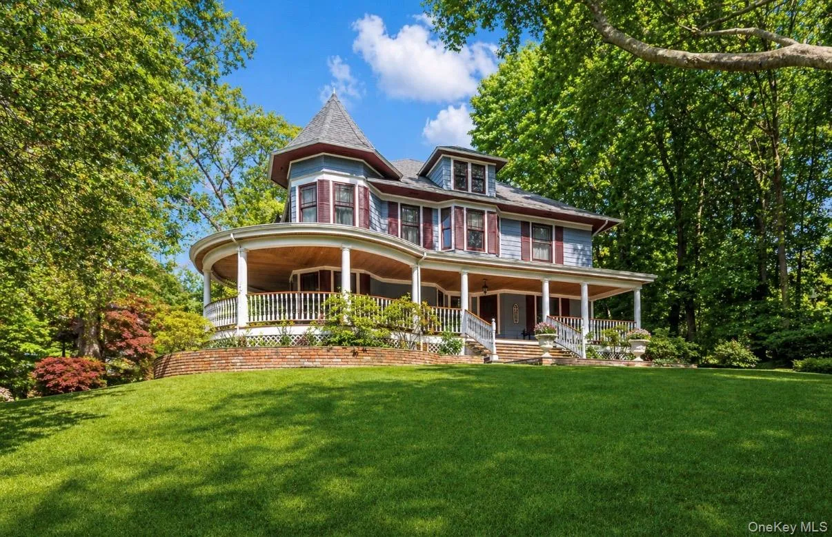 Victorian-style residence featuring a wraparound porch Victorian-style residence featuring a wraparound porch