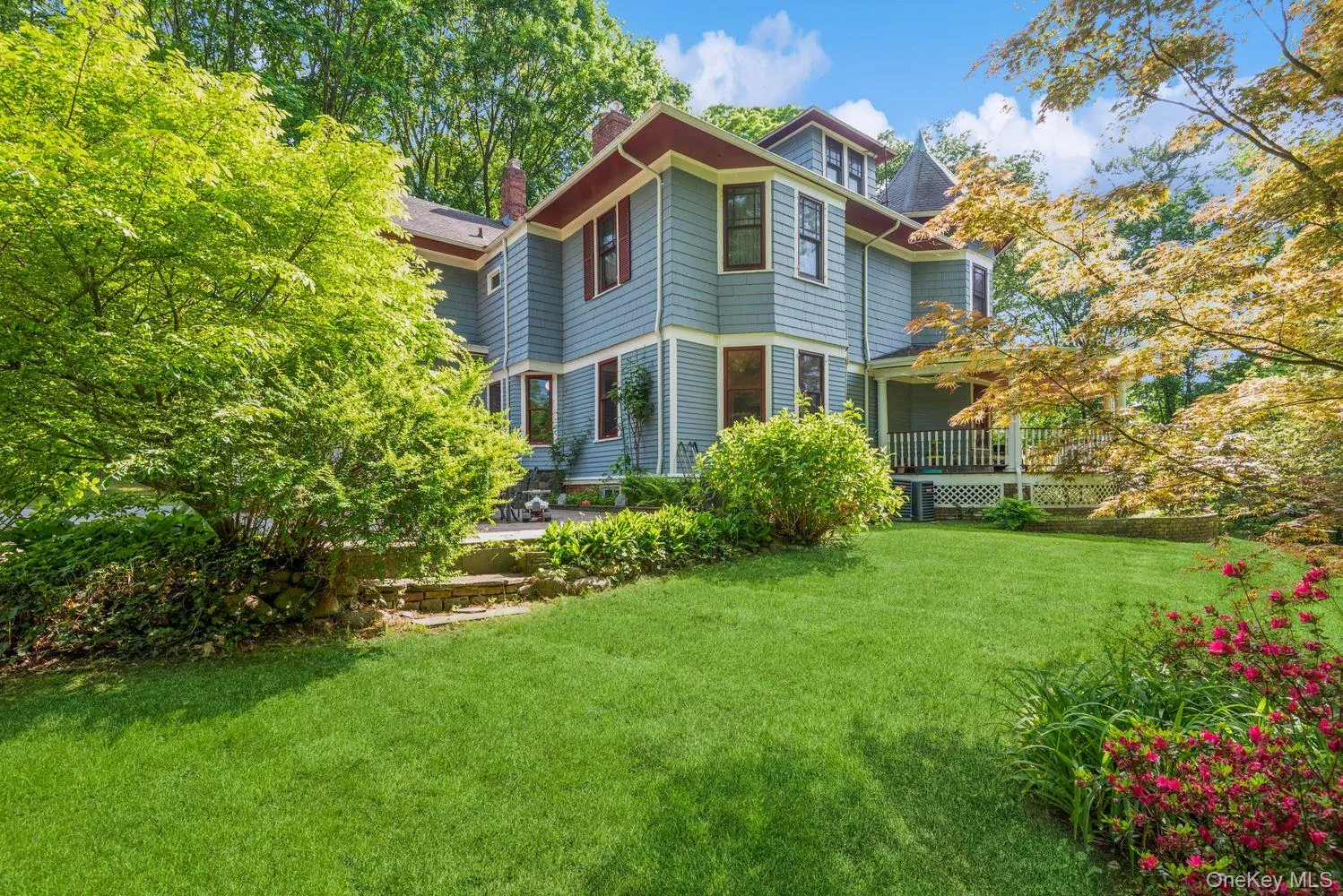 Lush green lawn with mature landscaping and flowering shrubs Lush green lawn with mature landscaping and flowering shrubs