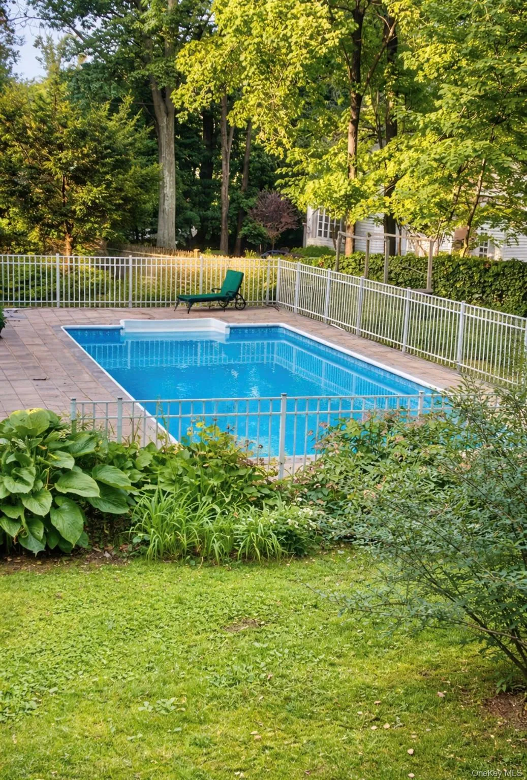 In-ground swimming pool with stone paver surround In-ground swimming pool with stone paver surround