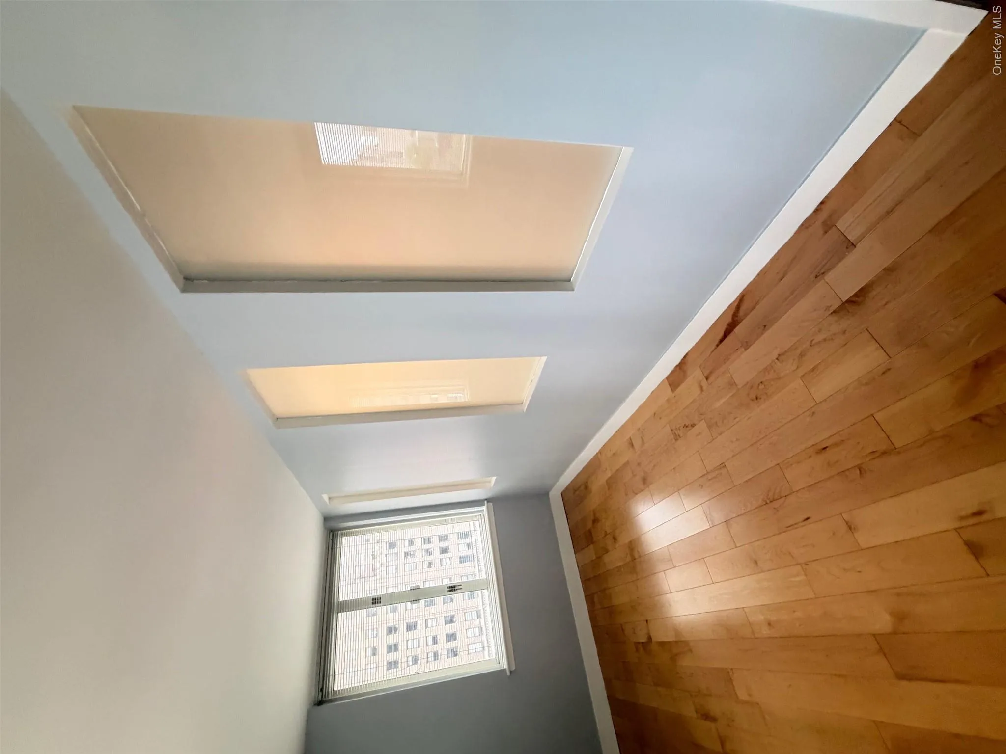 Light wood-finish flooring complemented by light blue walls and white trim Light wood-finish flooring complemented by light blue walls and white trim