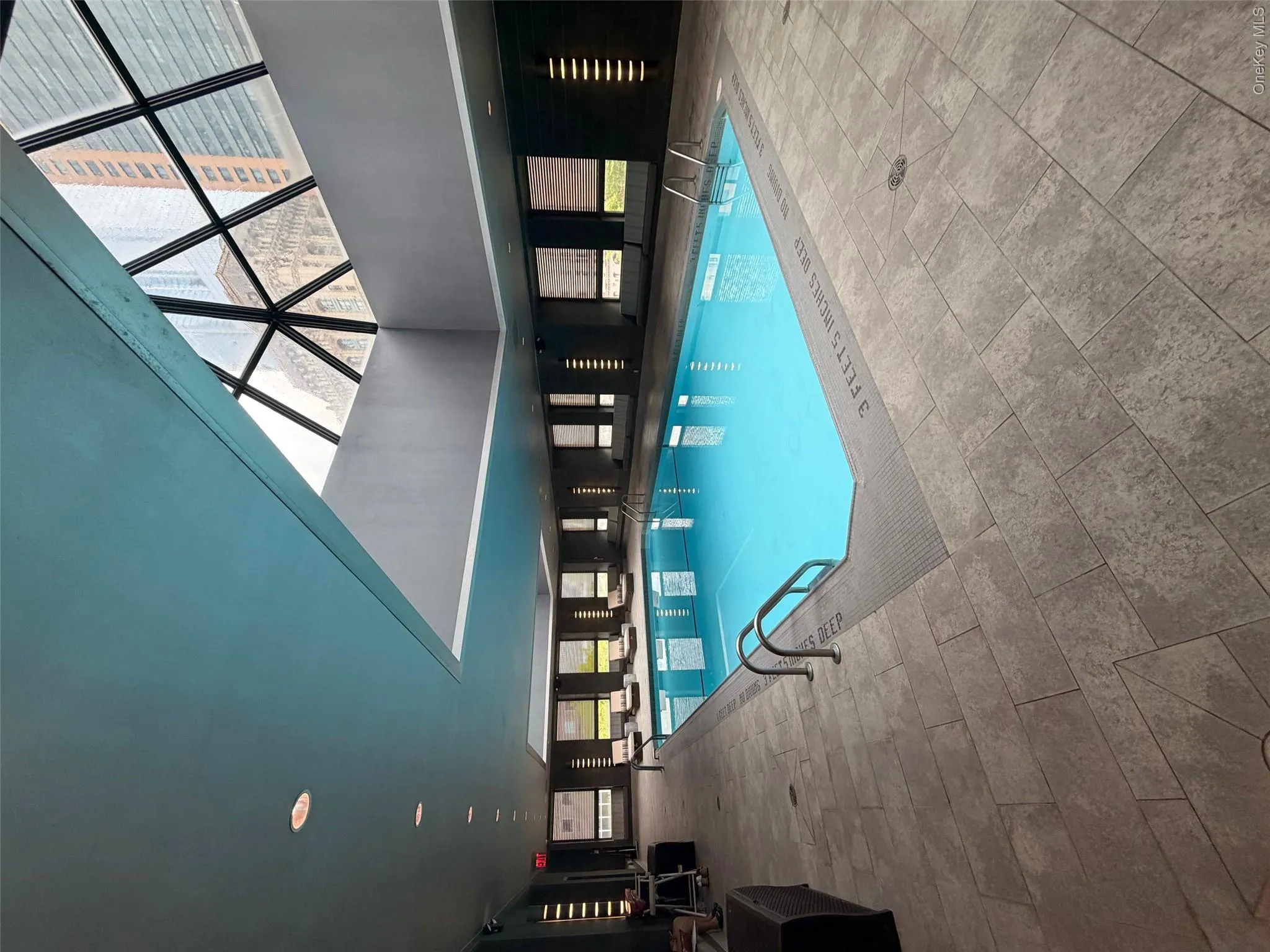Indoor swimming pool featuring a geometric skylight, recessed ceiling lighting, and perimeter windows Indoor swimming pool featuring a geometric skylight, recessed ceiling lighting, and perimeter windows