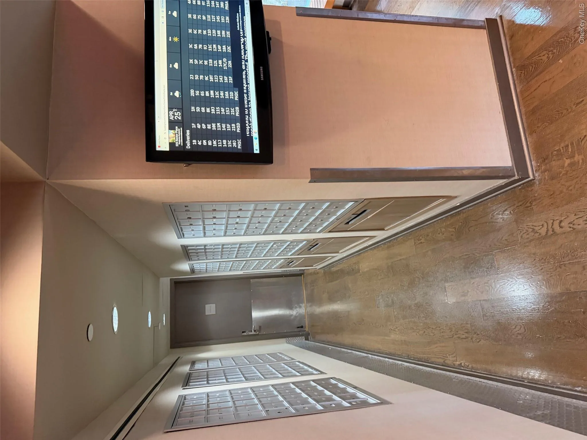 Hallway featuring wood-finish flooring, recessed lighting, and wall-mounted mailboxes Hallway featuring wood-finish flooring, recessed lighting, and wall-mounted mailboxes