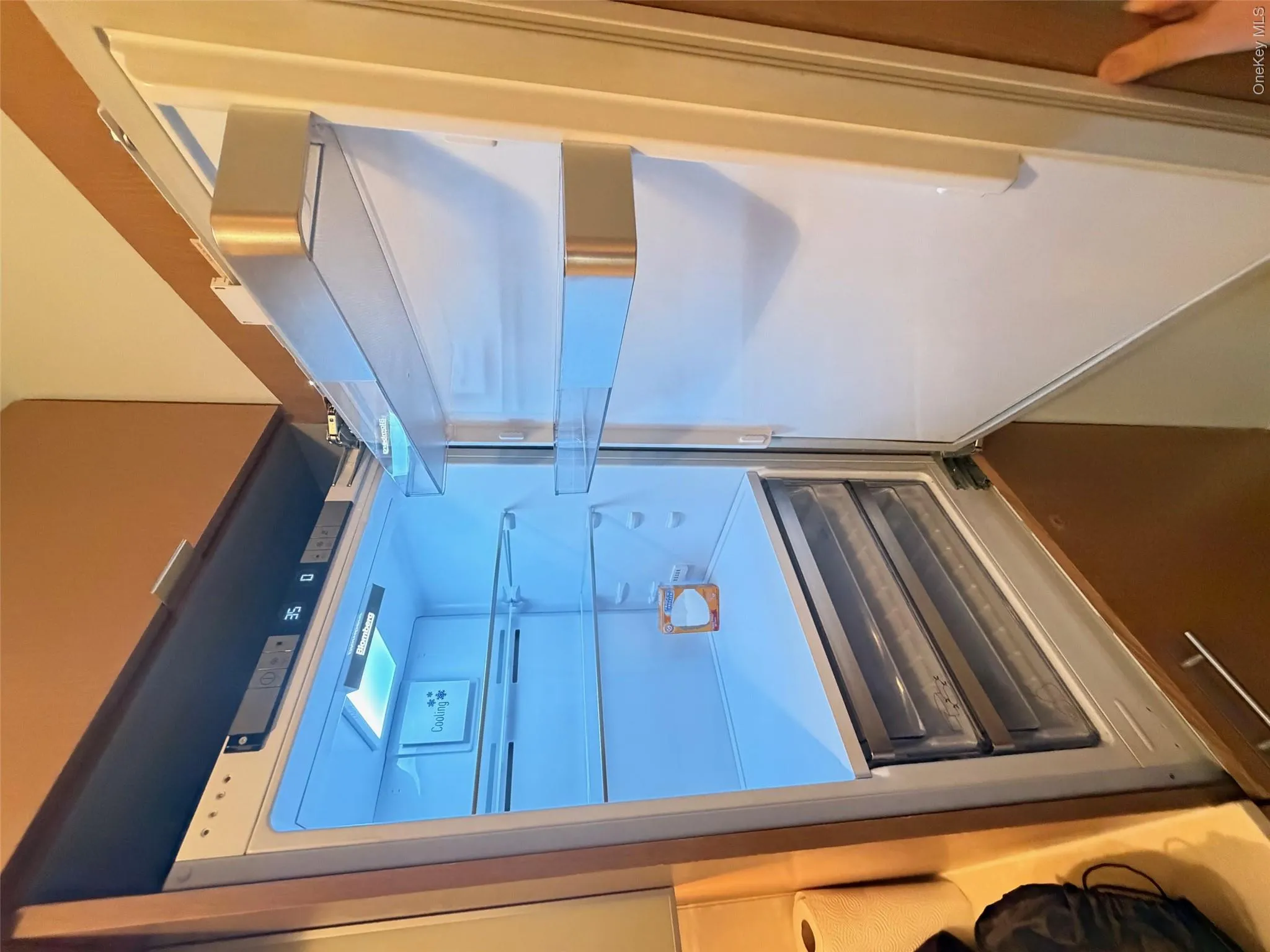 Built-in refrigerator with a digital temperature display, bright interior lighting, multiple adjustable glass shelves, and two transparent crisper drawers Built-in refrigerator with a digital temperature display, bright interior lighting, multiple adjustable glass shelves, and two transparent crisper drawers