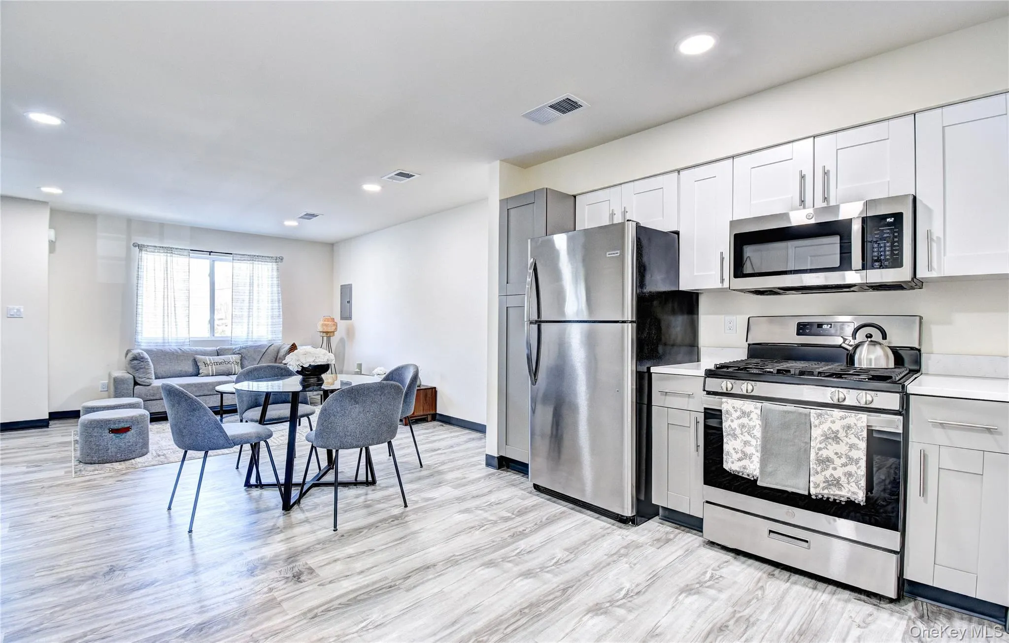 Kitchen featuring light hardwood / wood-style floors and stainless steel appliances Kitchen featuring light hardwood / wood-style floors and stainless steel appliances