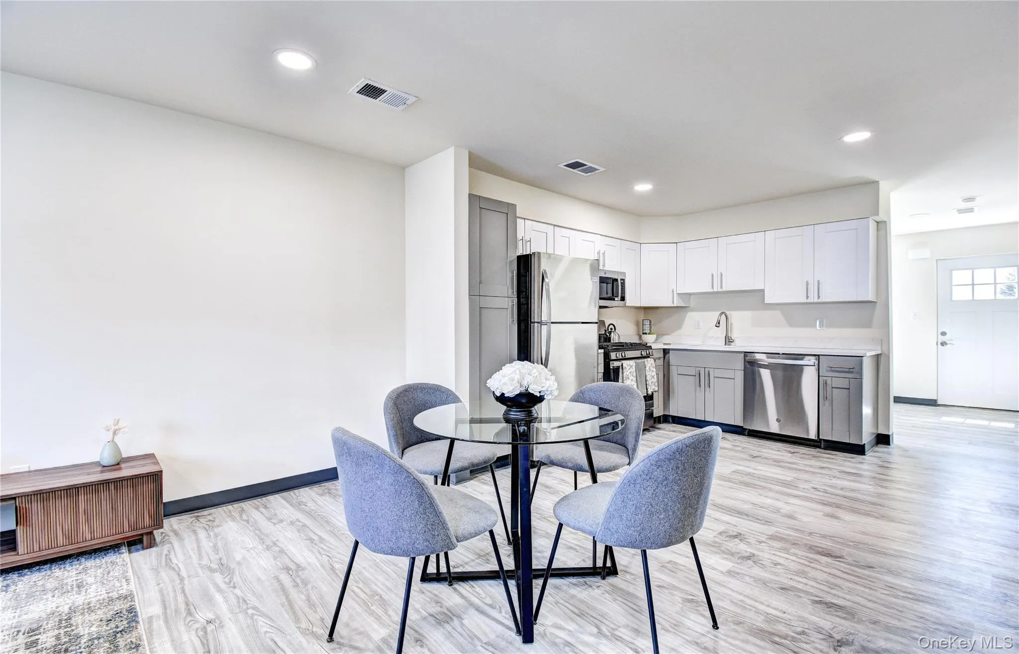 Dining space with light hardwood / wood-style floors Dining space with light hardwood / wood-style floors