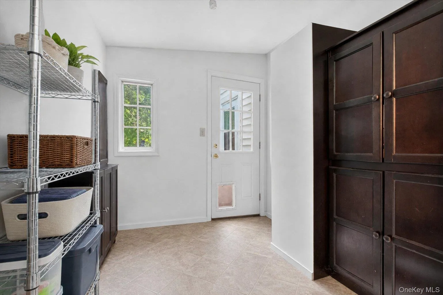 Mud room with storage cabinetry and access to outside. Mud room with storage cabinetry and access to outside.