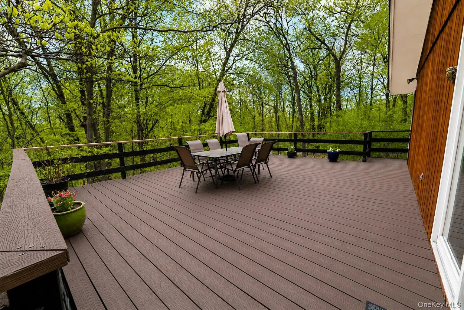 This generous, expansive deck is ideal for hosting large gatherings, dining al fresco, and entertaining outdoors. This generous, expansive deck is ideal for hosting large gatherings, dining al fresco, and entertaining outdoors.