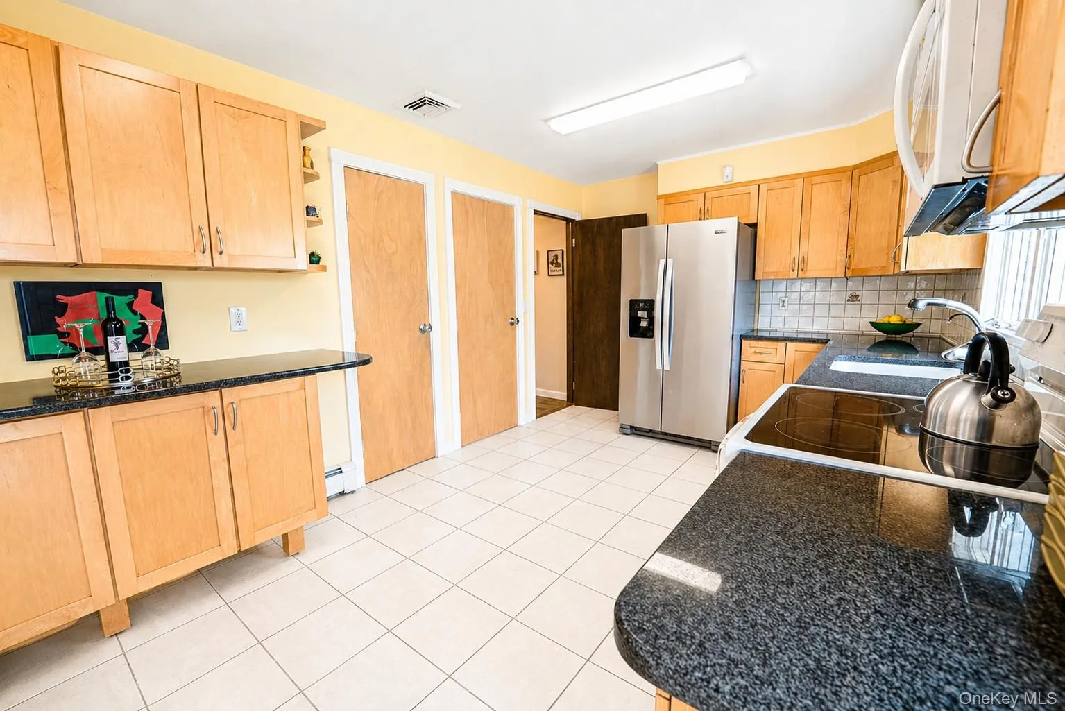 Another angle of the kitchen reveals a pantry and effortless connection to the dining room and wraparound deck paradise. Another angle of the kitchen reveals a pantry and effortless connection to the dining room and wraparound deck paradise.