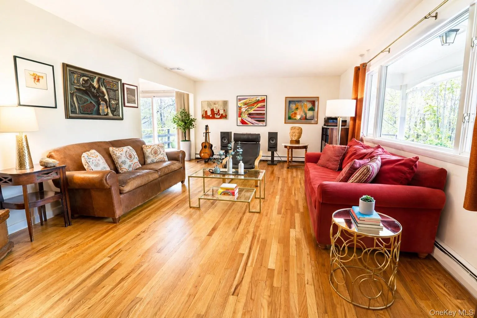 The inviting living room showcases hardwood floors and expansive windows that permeate the space with natural light. The inviting living room showcases hardwood floors and expansive windows that permeate the space with natural light.