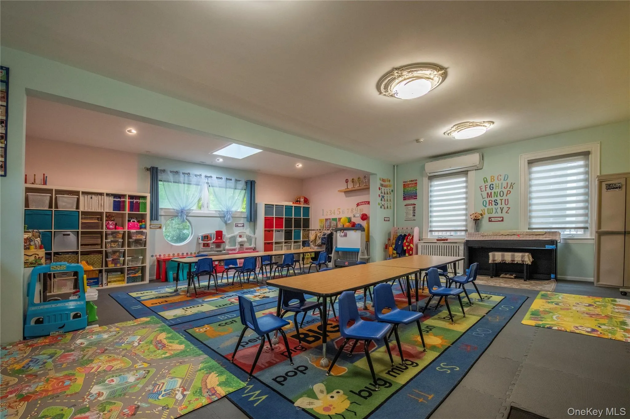 The spacious living room currently used as class room for day care. The spacious living room currently used as class room for day care.