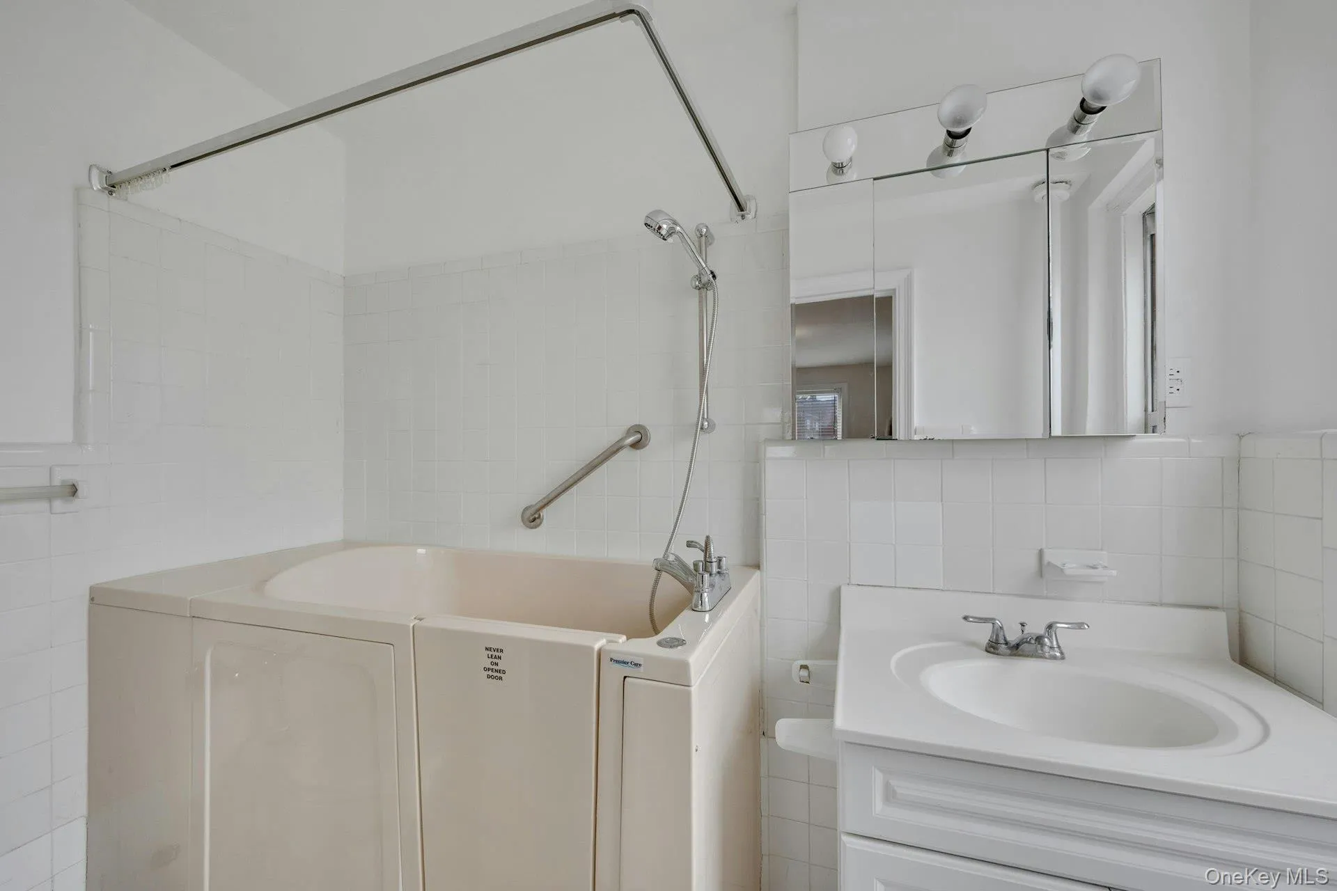 Primary Bathroom with step-in bathtub. Primary Bathroom with step-in bathtub.