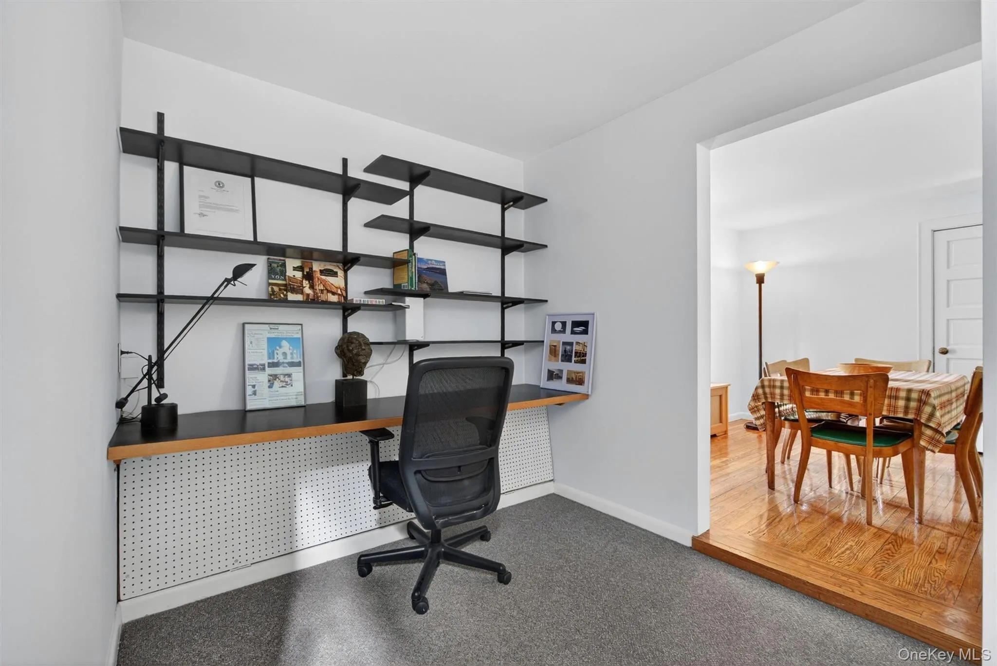 A flexible bonus space off the foyer, currently configured as an office, offers closet storage and easy flow into the dining room. A flexible bonus space off the foyer, currently configured as an office, offers closet storage and easy flow into the dining room.