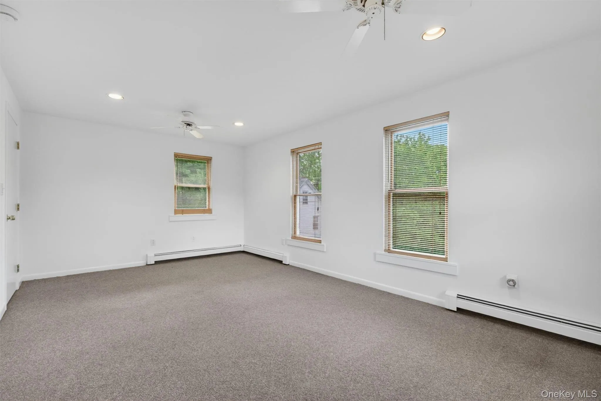 The second-floor bedroom is filled with natural light from the tall windows. The second-floor bedroom is filled with natural light from the tall windows.