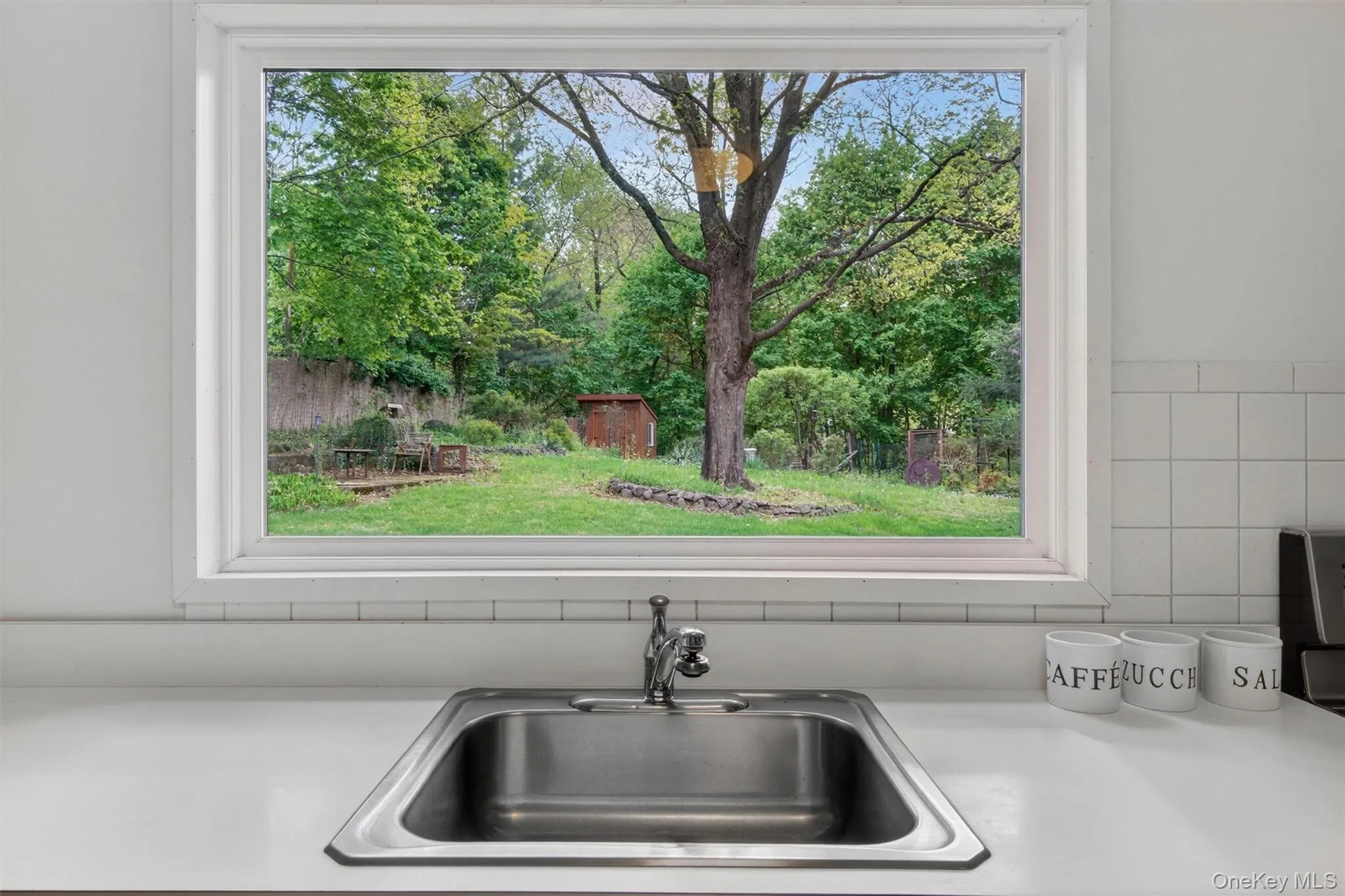 A view of your green oasis through the picture window over the sink. A view of your green oasis through the picture window over the sink.