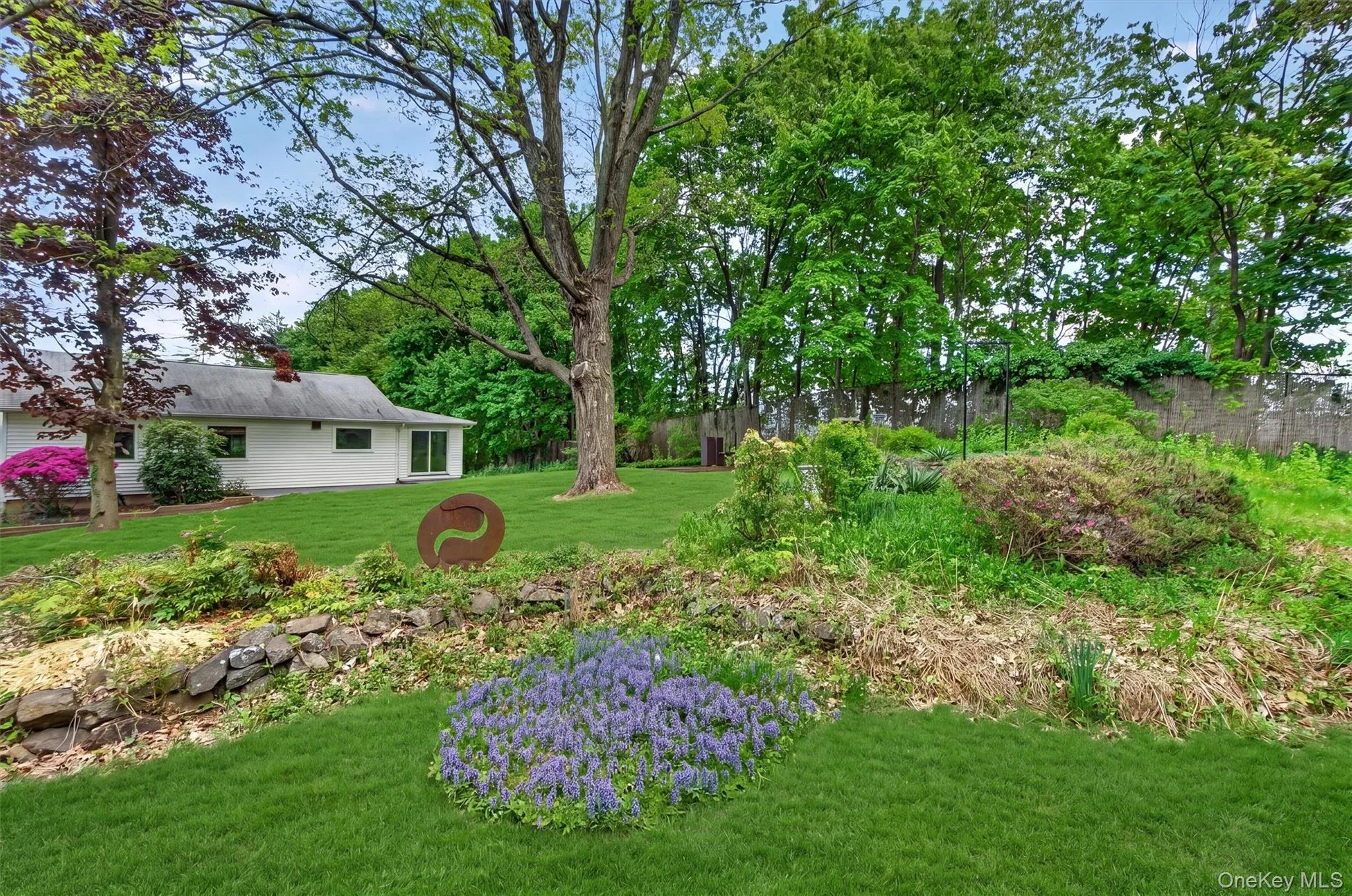 Colorful perennial plantings and established landscaping create a serene and enjoyable outdoor setting. Colorful perennial plantings and established landscaping create a serene and enjoyable outdoor setting.