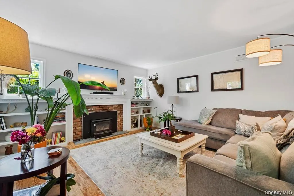 Spacious living room with wood burning fireplace. Spacious living room with wood burning fireplace.