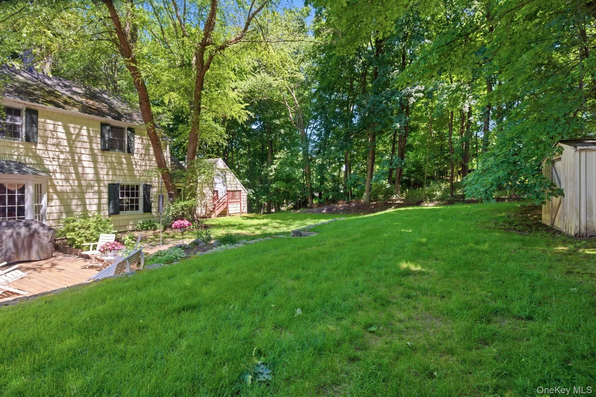 The backyard offers open lawn space, mature plantings, and a screened porch creating a natural extension of the home. The backyard offers open lawn space, mature plantings, and a screened porch creating a natural extension of the home.