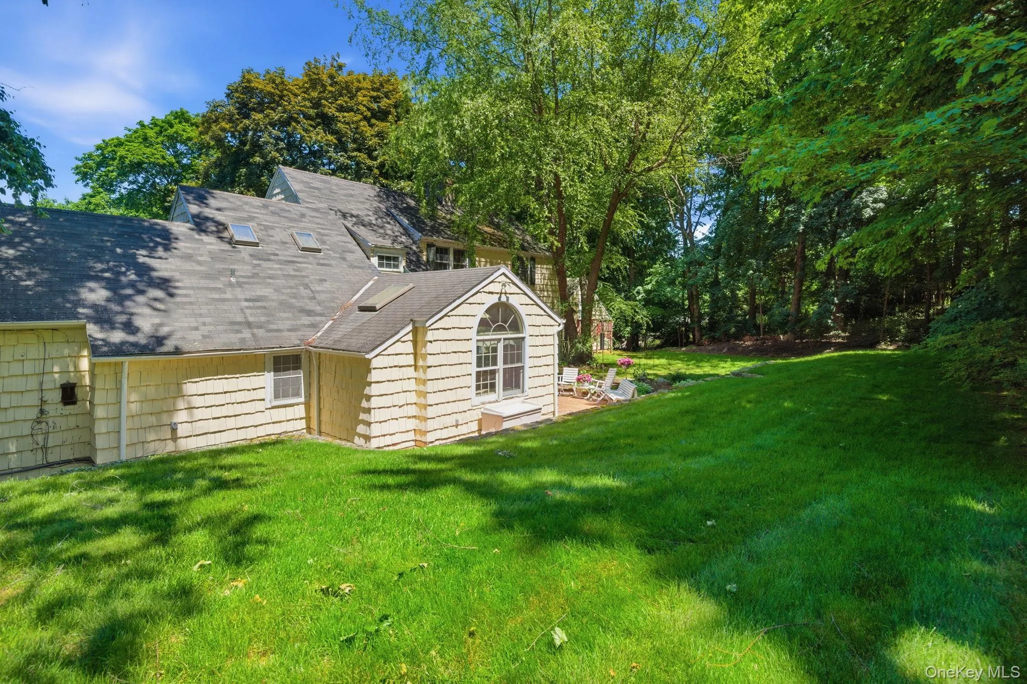 The family room addition features a striking arched window and skylights, visible from the expansive backyard. The family room addition features a striking arched window and skylights, visible from the expansive backyard.