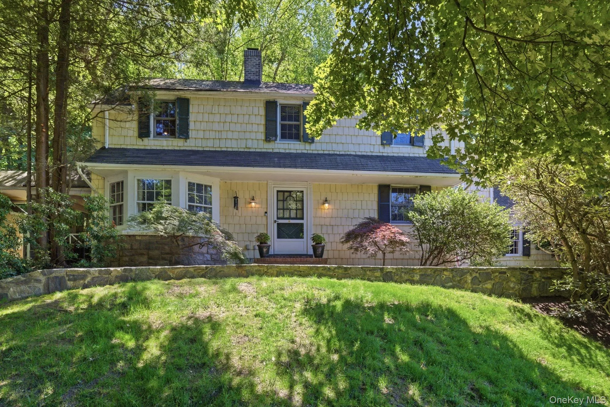 Cedar shake siding, classic shutters, and a covered entry give this Seven Bridges Colonial its enduring street presence. Cedar shake siding, classic shutters, and a covered entry give this Seven Bridges Colonial its enduring street presence.