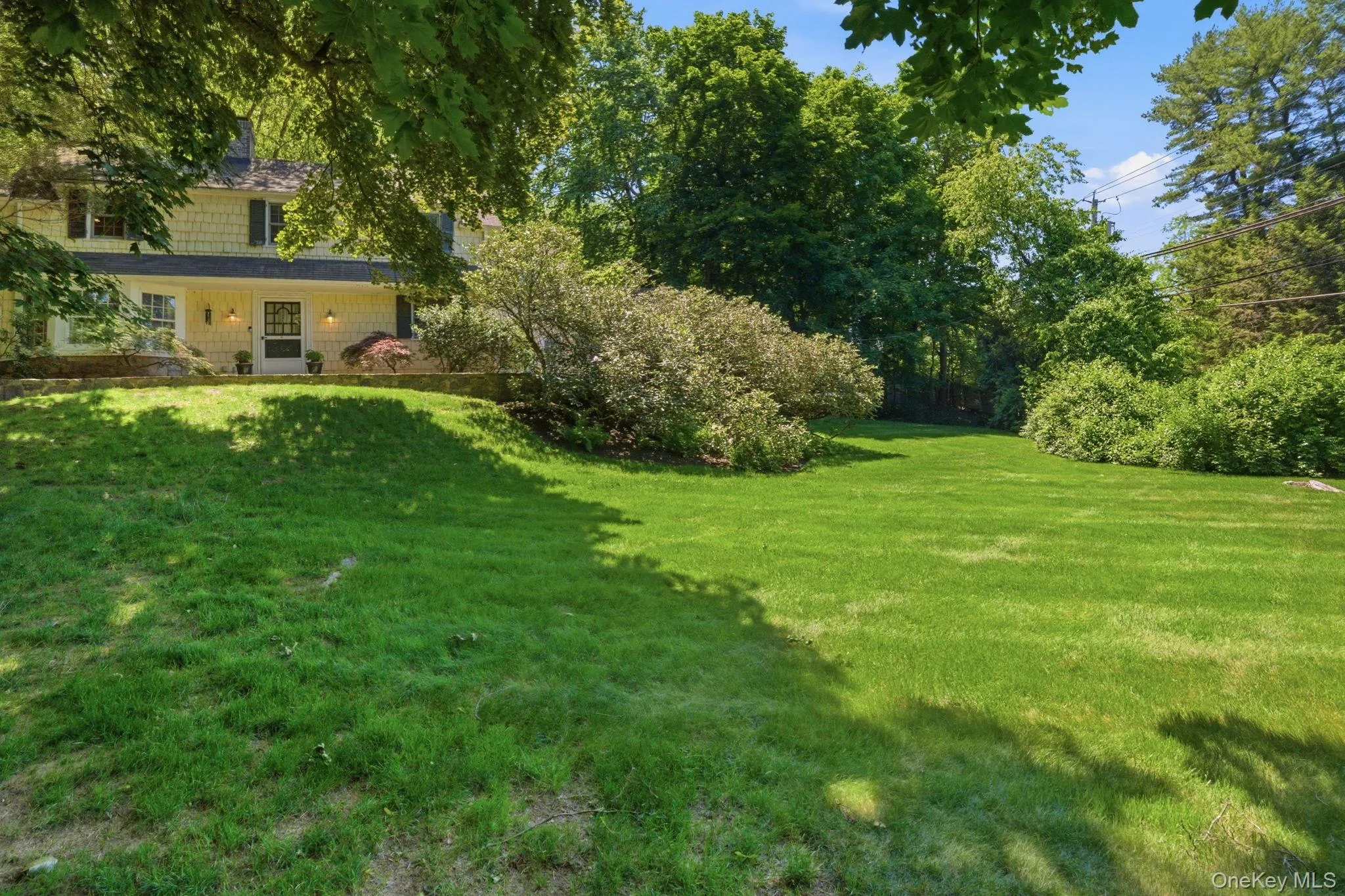 The corner lot setting offers generous green space, mature trees, and natural privacy on all sides. The corner lot setting offers generous green space, mature trees, and natural privacy on all sides.