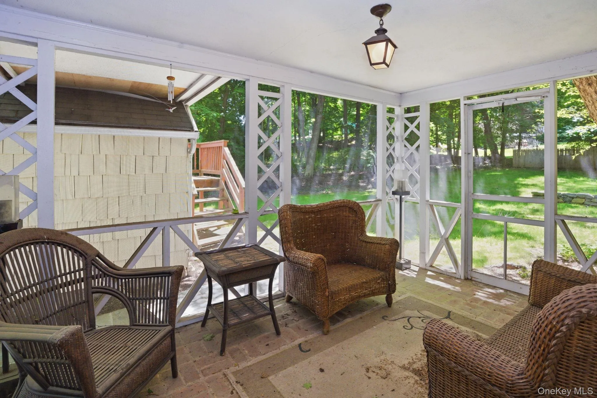The screened porch off the living room offers a private wooded view and a natural extension of the main living space. The screened porch off the living room offers a private wooded view and a natural extension of the main living space.
