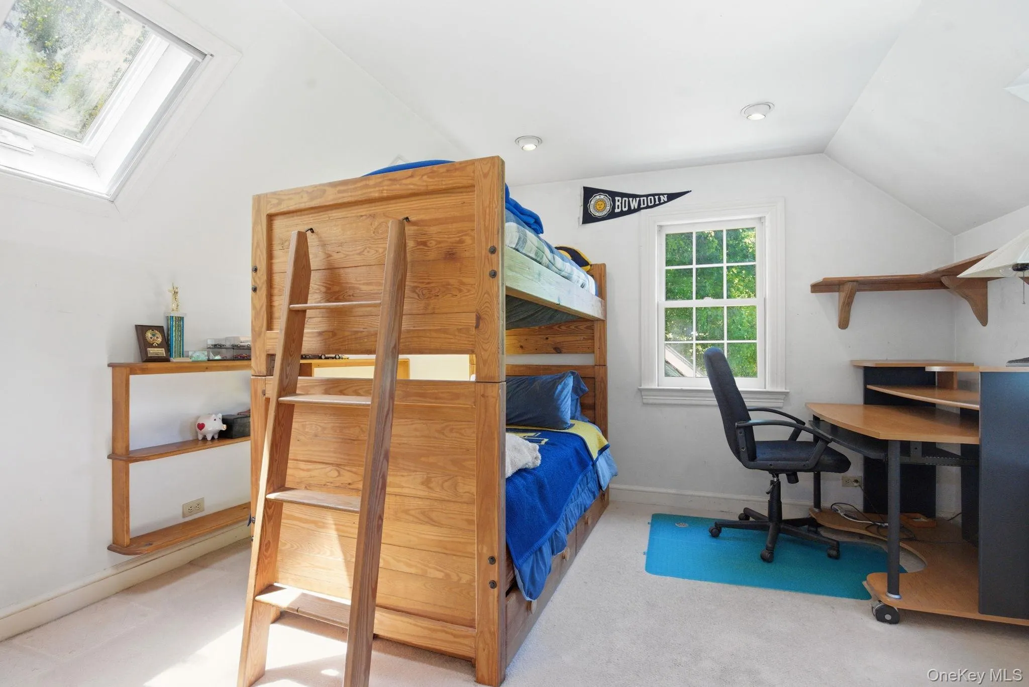 A skylit bedroom with vaulted ceiling and tree-framed windows offers good natural light and room to make it your own. A skylit bedroom with vaulted ceiling and tree-framed windows offers good natural light and room to make it your own.