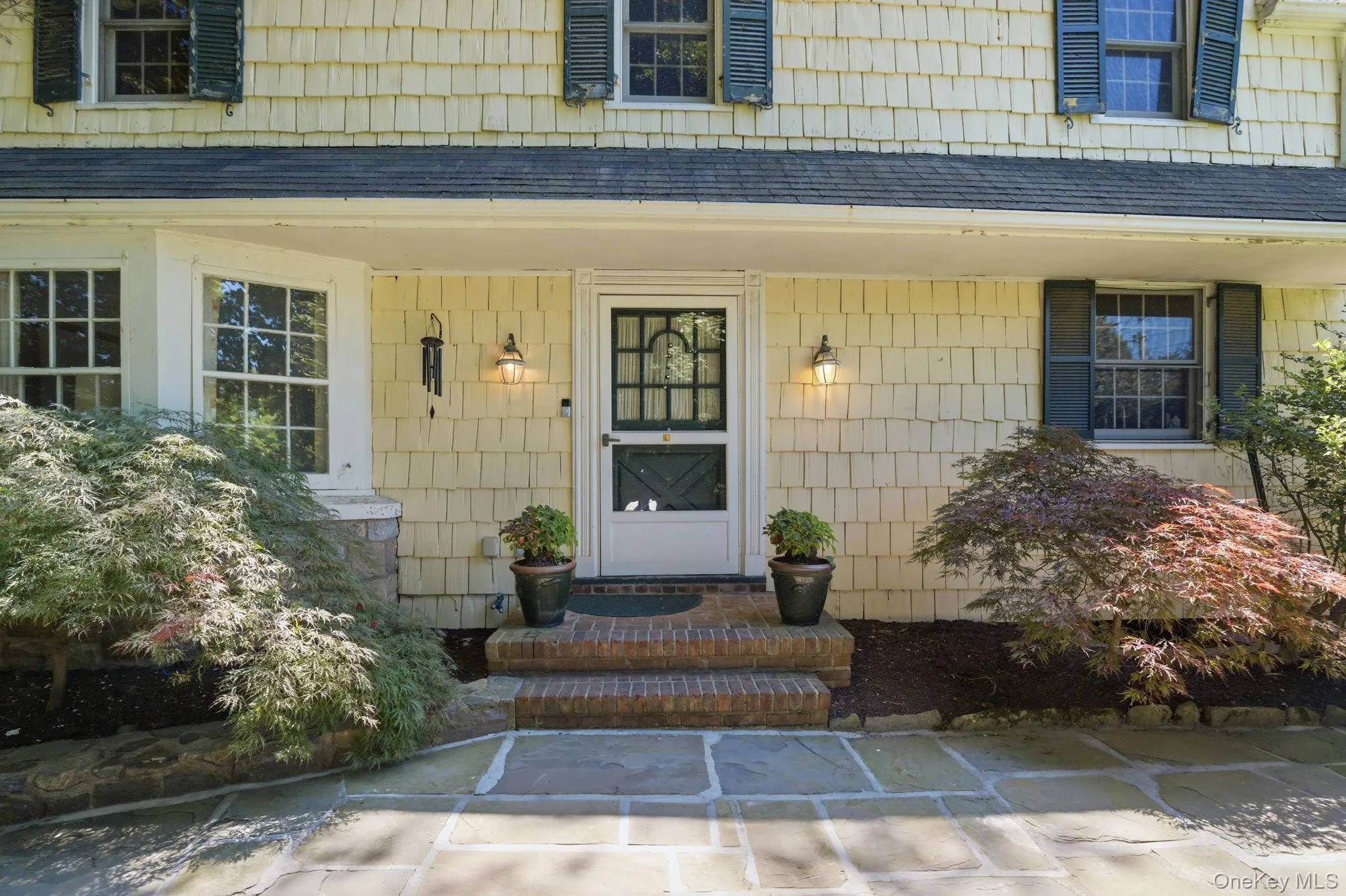 Brick steps, a flagstone landing, and lantern lighting set the tone at the front door of this 1934 Colonial. Brick steps, a flagstone landing, and lantern lighting set the tone at the front door of this 1934 Colonial.