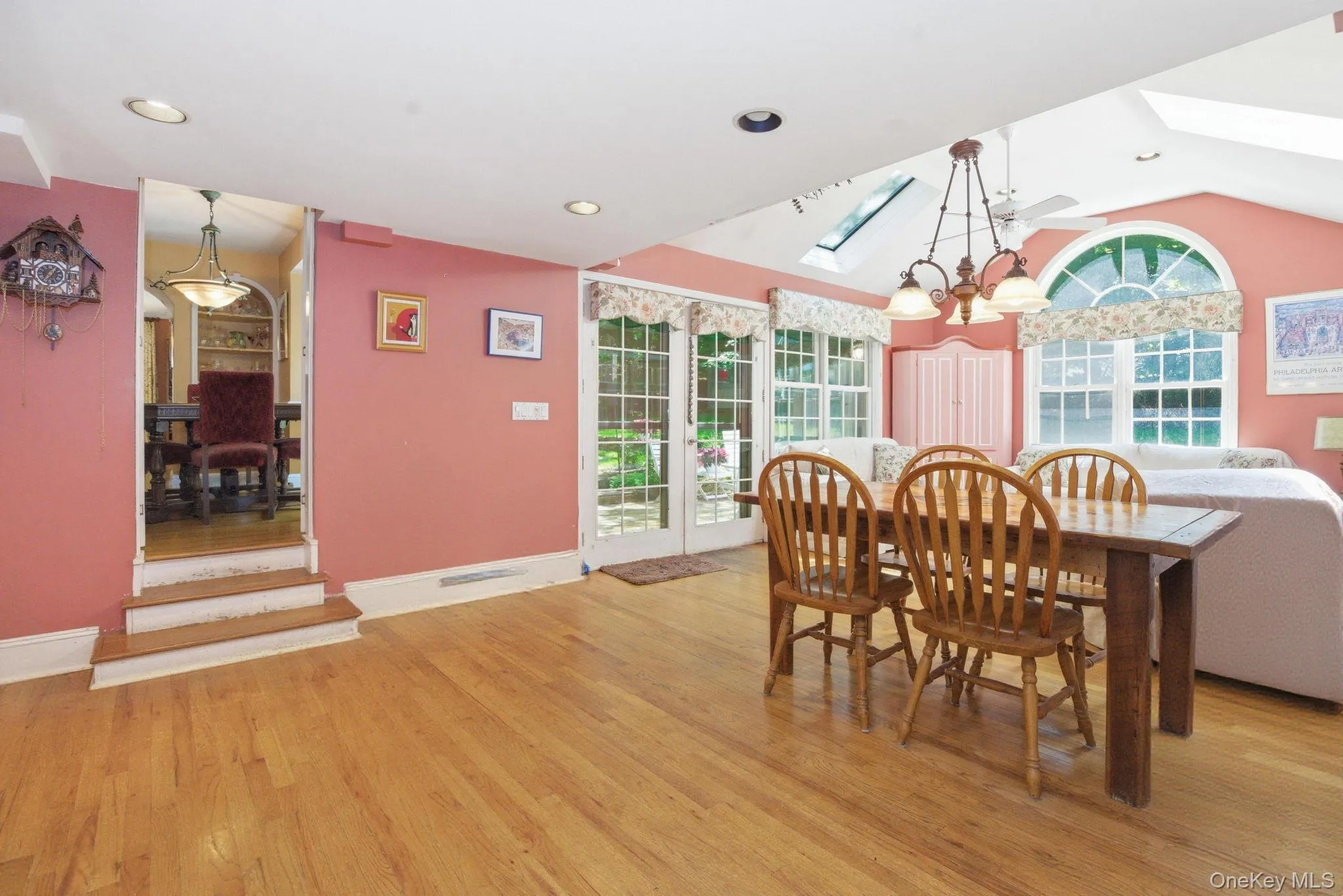 The family room and breakfast room flow together under vaulted ceilings with skylights, hardwood floors, and French doors leading to the deck. The family room and breakfast room flow together under vaulted ceilings with skylights, hardwood floors, and French doors leading to the deck.