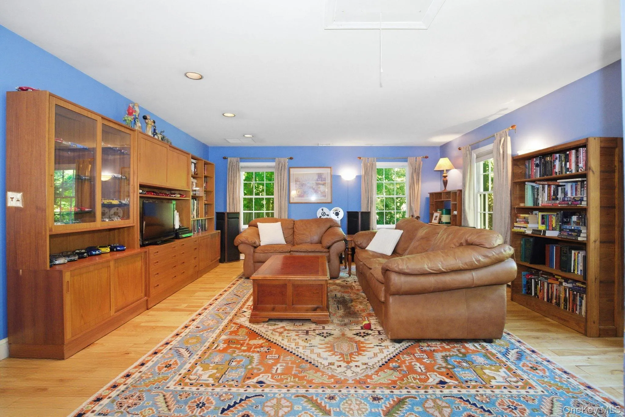 Hardwood floors, built-in cabinetry, and multiple windows give this first-floor primary suite standout functionality and flexibility. Hardwood floors, built-in cabinetry, and multiple windows give this first-floor primary suite standout functionality and flexibility.