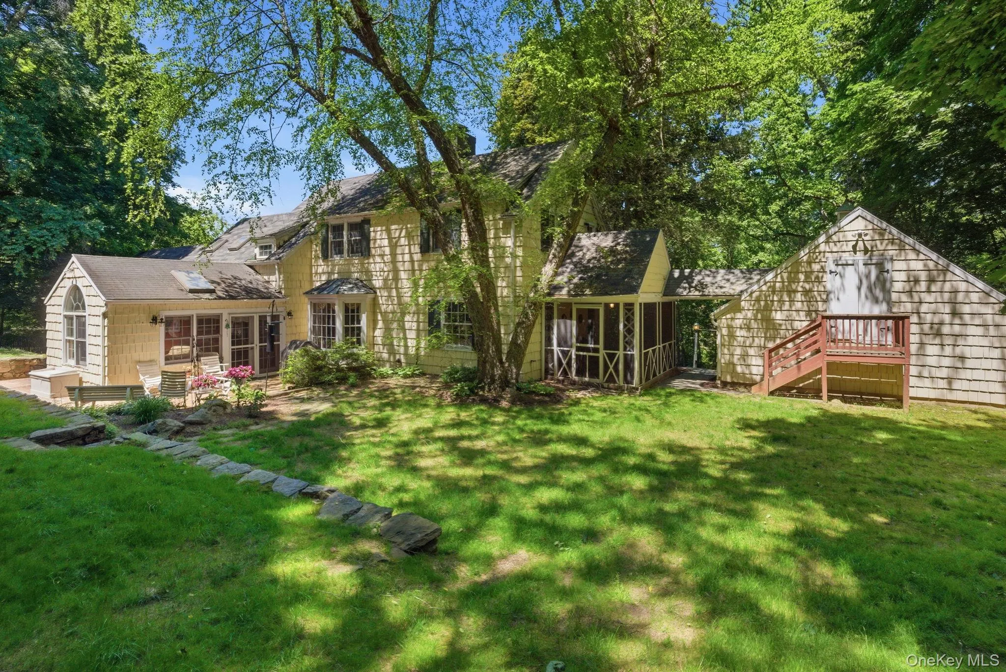 Stone walls, layered plantings, and a wooded backdrop make the backyard one of the most compelling features of this Chappaqua Colonial. Stone walls, layered plantings, and a wooded backdrop make the backyard one of the most compelling features of this Chappaqua Colonial.