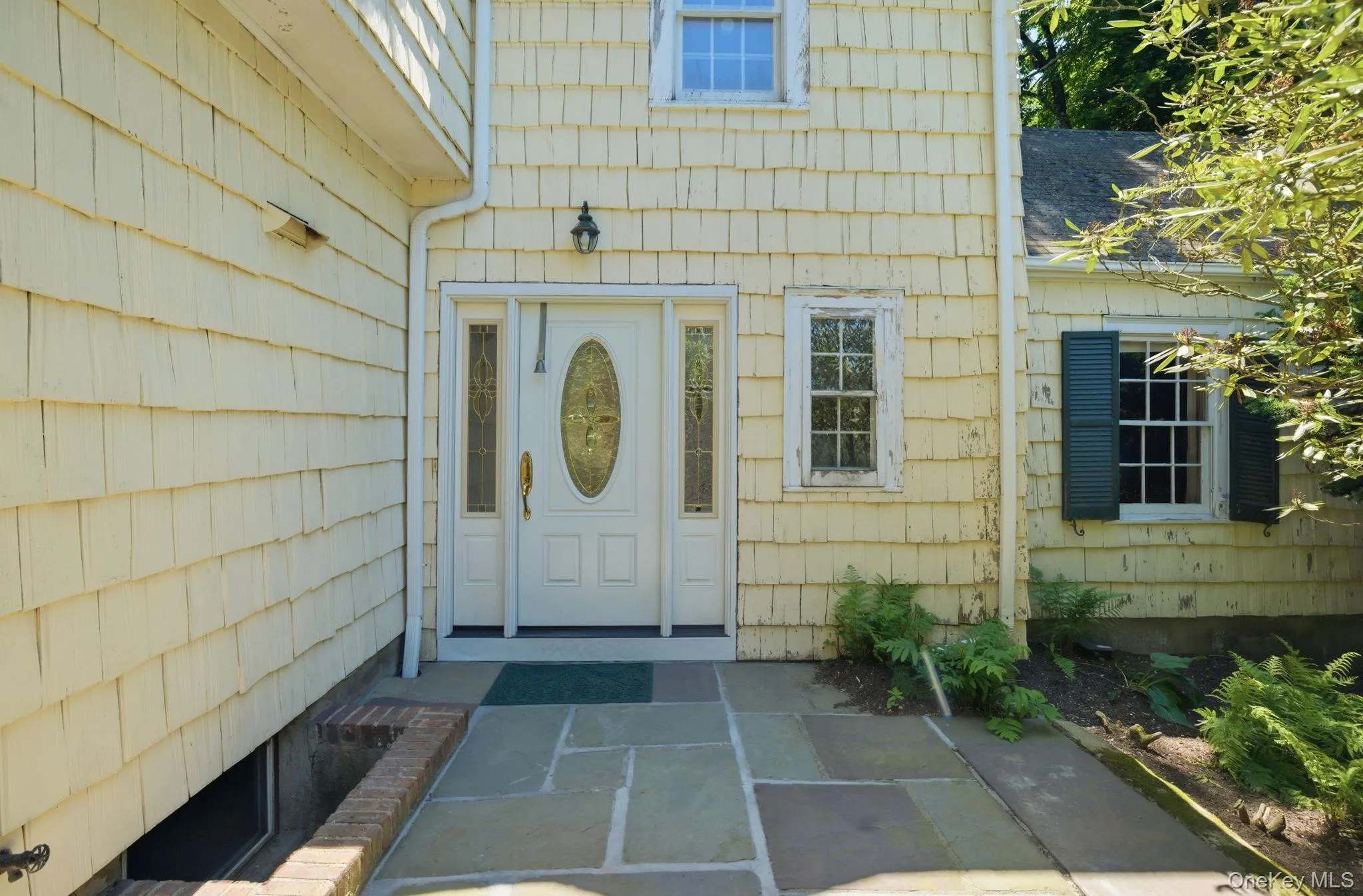 A second entry point with a stained glass door and flagstone surround adds character to the home. A second entry point with a stained glass door and flagstone surround adds character to the home.