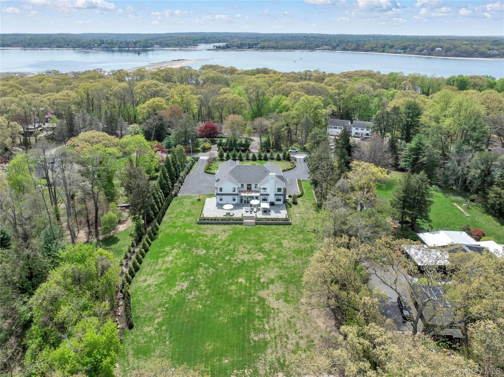 Expansive property featuring a large residence, a paved driveway, and mature landscaping Expansive property featuring a large residence, a paved driveway, and mature landscaping