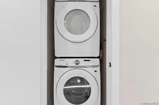 Stackable washer and dryer unit within an integrated closet space Stackable washer and dryer unit within an integrated closet space