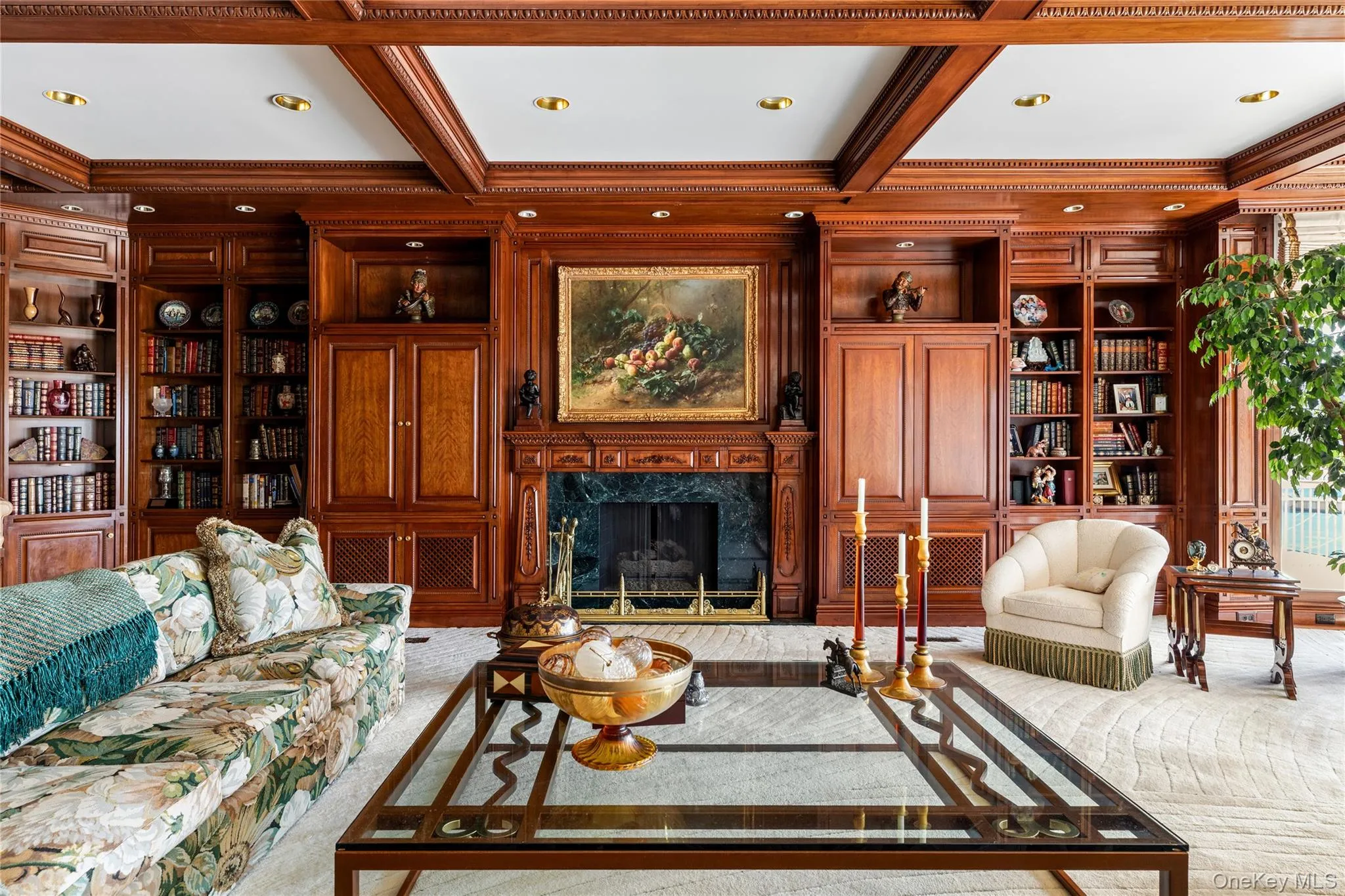 Elegant wood-paneled room featuring extensive built-in cabinetry and shelving Elegant wood-paneled room featuring extensive built-in cabinetry and shelving