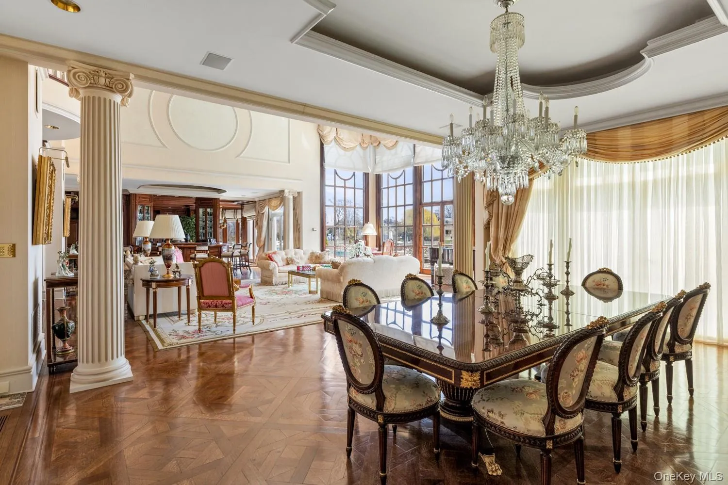 Formal dining area featuring a large crystal chandelier and parquet wood-finish flooring Formal dining area featuring a large crystal chandelier and parquet wood-finish flooring