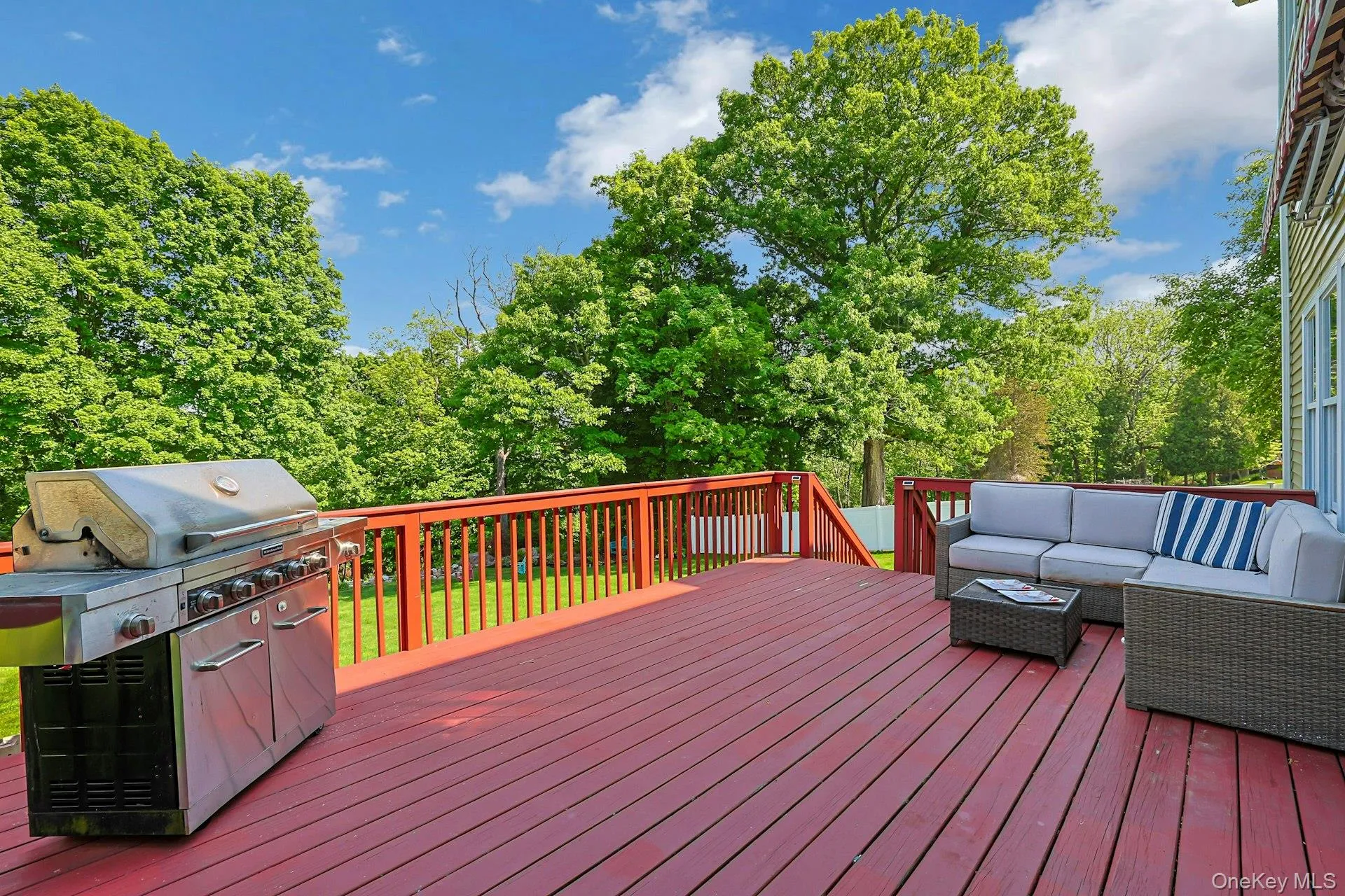 Spacious deck with 180 degree views of the flat back yard and acres beyond, creating an easy extension of the home’s living space to its beautiful outdoors. Spacious deck with 180 degree views of the flat back yard and acres beyond, creating an easy extension of the home’s living space to its beautiful outdoors.