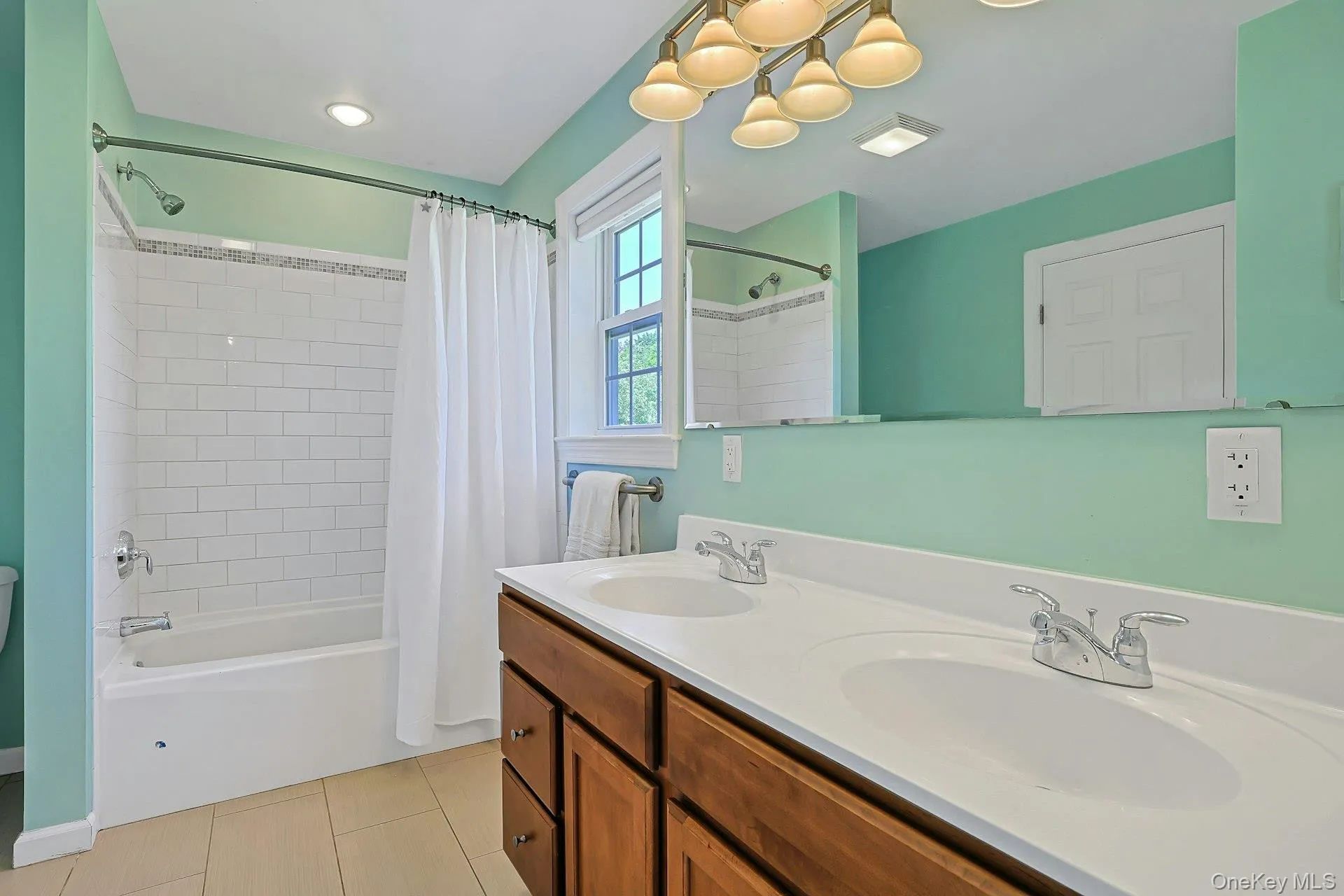 Full hall bathroom conveniently located near the bedrooms featuring double sinks and a tub/shower combination. Full hall bathroom conveniently located near the bedrooms featuring double sinks and a tub/shower combination.