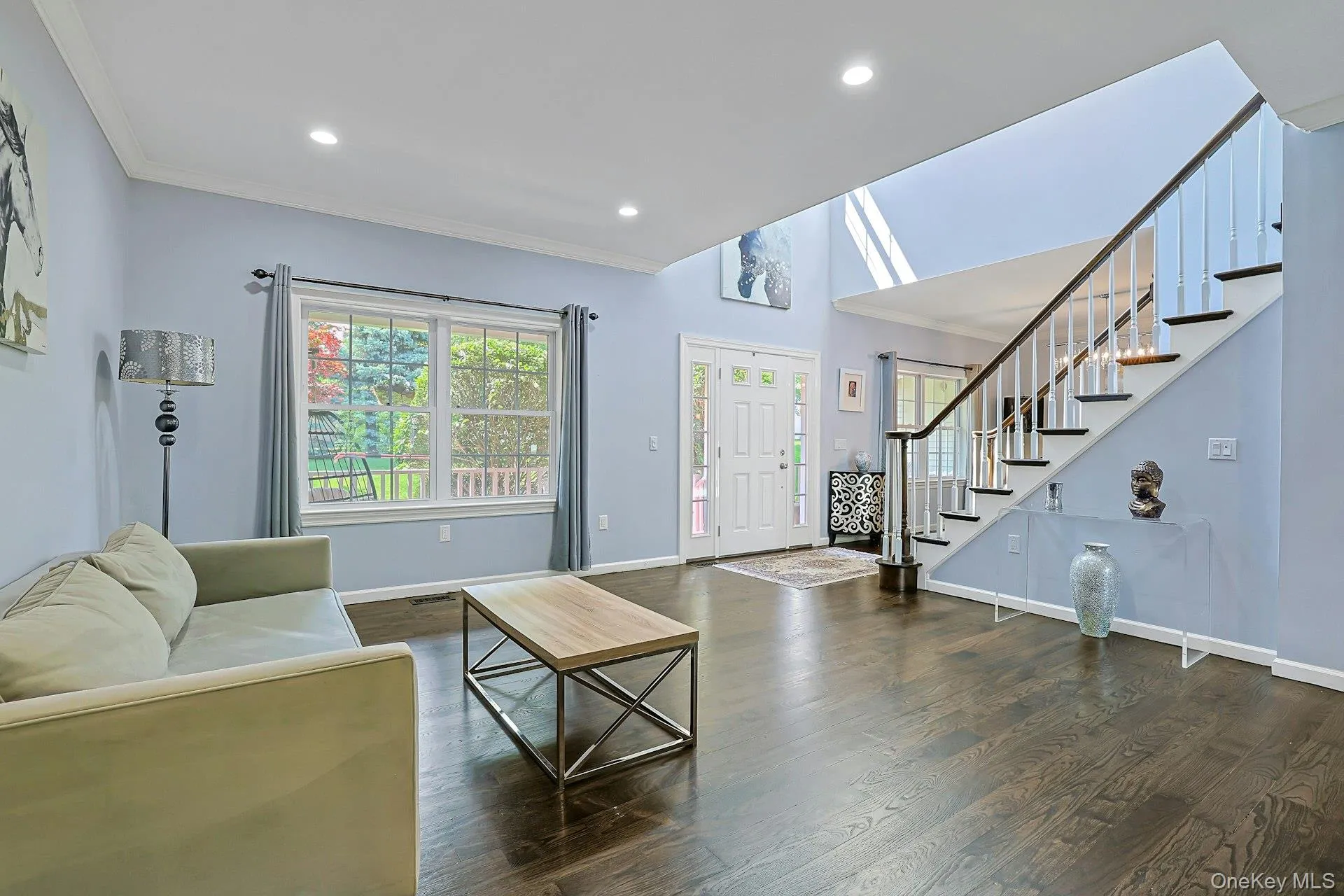 Bright and welcoming sitting area of the enormous living room, featuring rich hardwood floors, and an abundance of natural light. An inviting space to relax. Bright and welcoming sitting area of the enormous living room, featuring rich hardwood floors, and an abundance of natural light. An inviting space to relax.