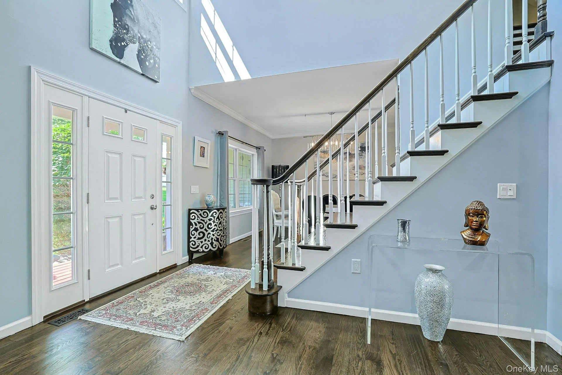 Light-filled entry foyer featuring a graceful staircase, a grand welcome to this home's interior. Light-filled entry foyer featuring a graceful staircase, a grand welcome to this home's interior.