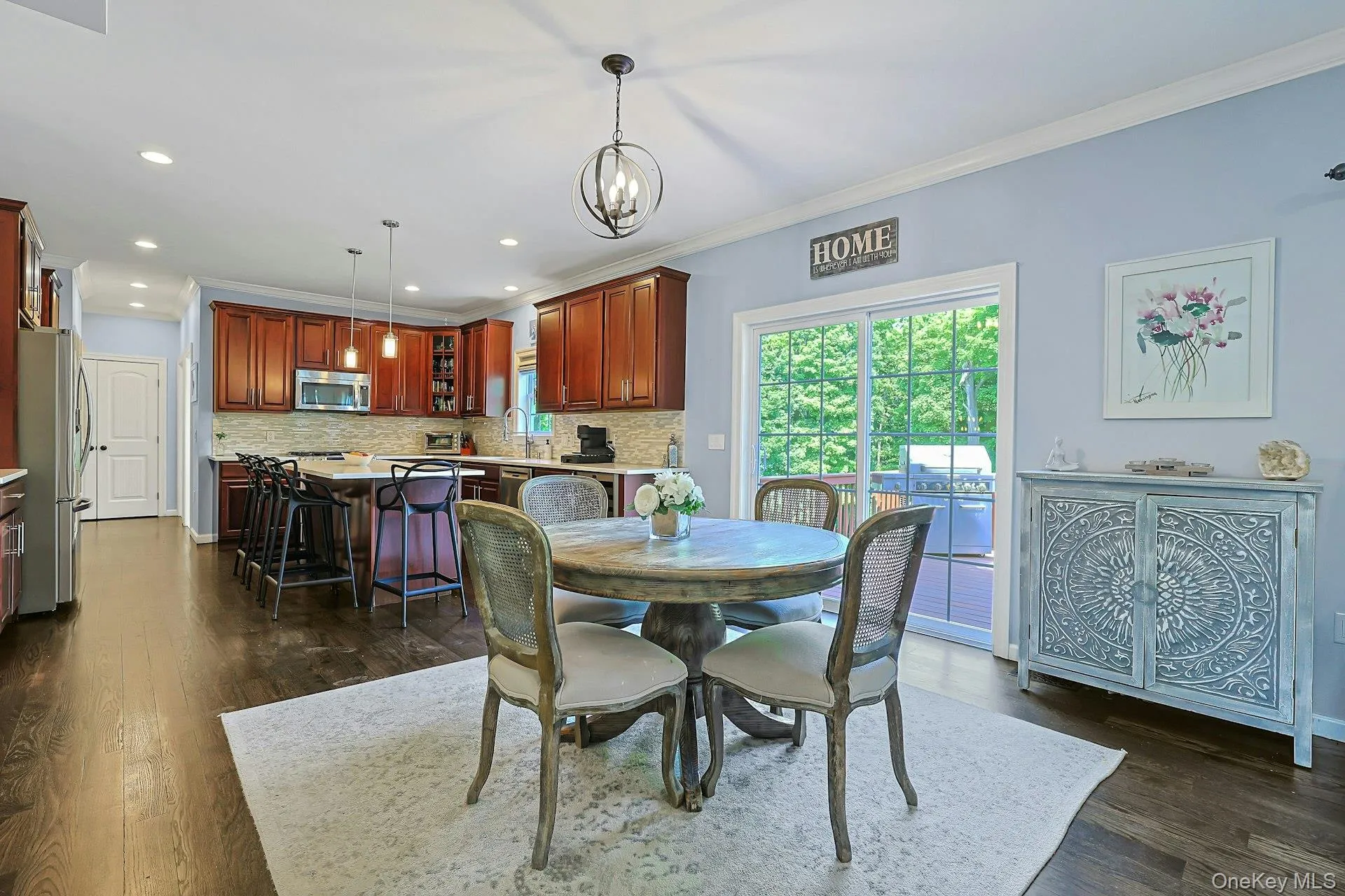 Open-concept kitchen featuring hardwood floors, eat-in area with space for a table for casual meals, and sliding glass doors that bring in natural light and provide easy access to the enormous deck , rear yard and exterior. Open-concept kitchen featuring hardwood floors, eat-in area with space for a table for casual meals, and sliding glass doors that bring in natural light and provide easy access to the enormous deck , rear yard and exterior.