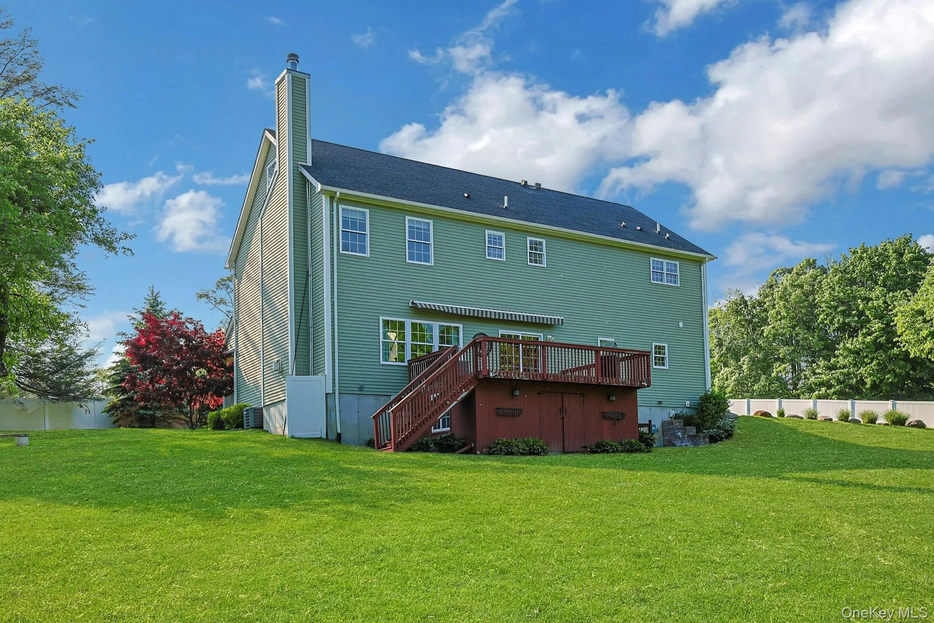 Rear view showing expansive deck and large flat backyard with plenty of open space to enjoy the property’s magnificent setting. Rear view showing expansive deck and large flat backyard with plenty of open space to enjoy the property’s magnificent setting.