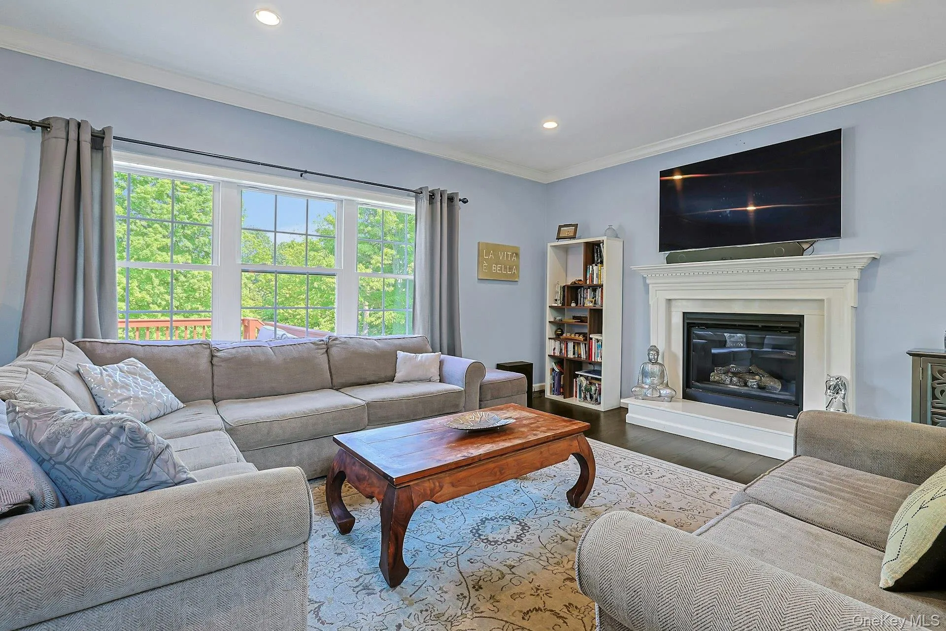 Living room with marble gas fireplace, large picture windows, and ample space for gathering and entertaining. Living room with marble gas fireplace, large picture windows, and ample space for gathering and entertaining.