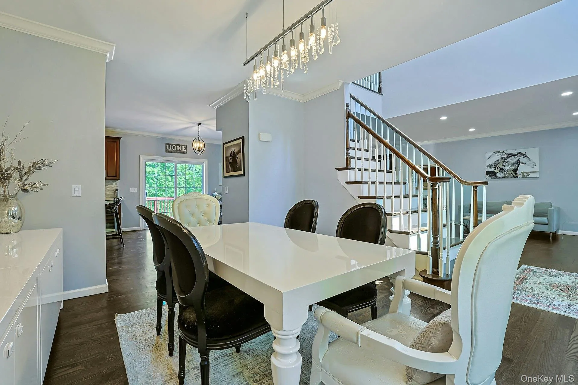 Dining room and view showcasing the beautiful staircase and the home’s inviting layout. Dining room and view showcasing the beautiful staircase and the home’s inviting layout.