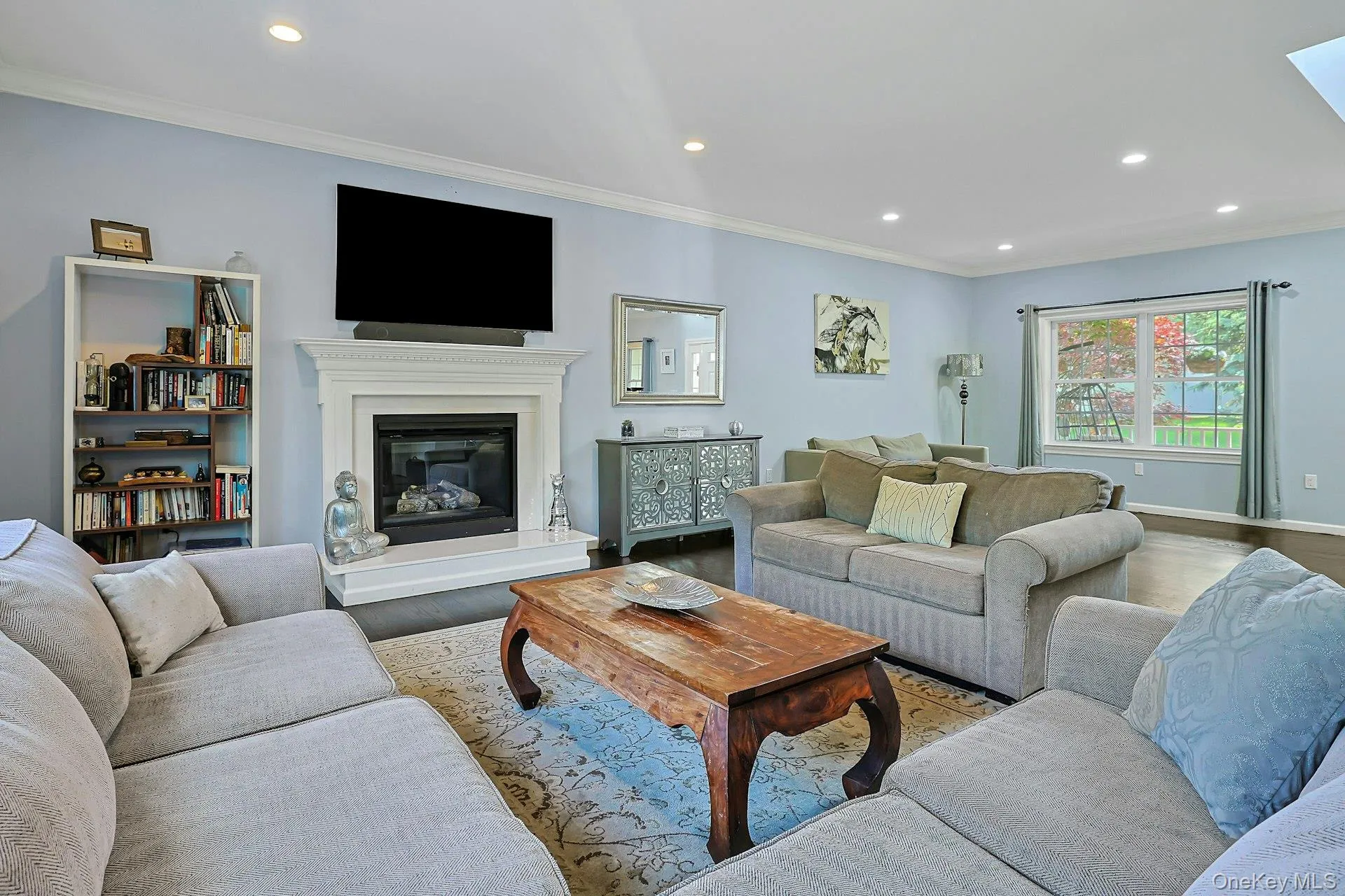 A bright and inviting living room with gas fireplace with white mantel and hearth, that enhances the room’s charm and warmth. A bright and inviting living room with gas fireplace with white mantel and hearth, that enhances the room’s charm and warmth.