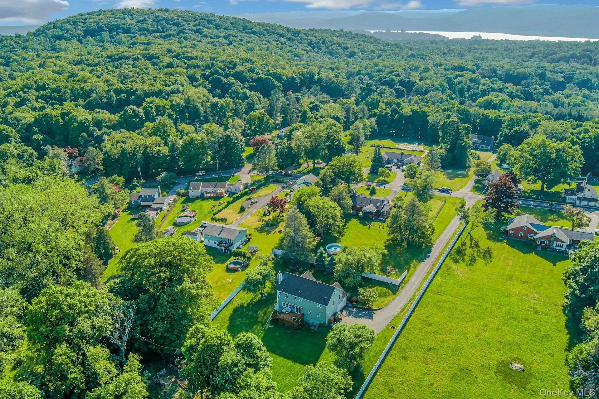 Beautiful aerial view showcasing the property and surrounding landscape. That IS the Hudson River glistening in the distance, only a few minutes away! Beautiful aerial view showcasing the property and surrounding landscape. That IS the Hudson River glistening in the distance, only a few minutes away!