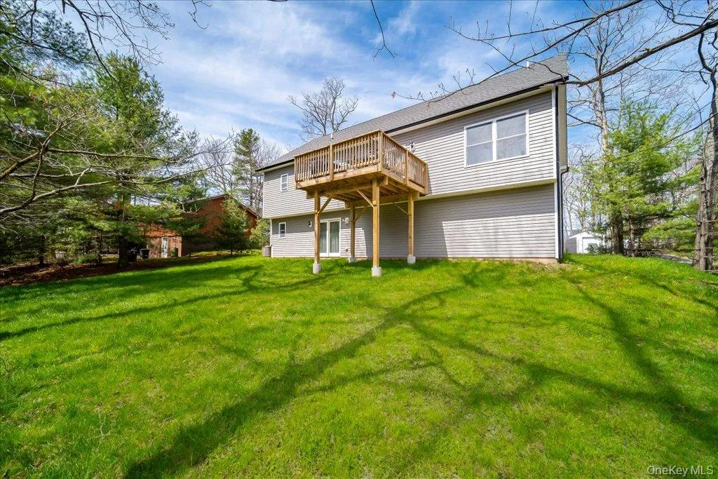 Spacious green lawn with a gray siding exterior Spacious green lawn with a gray siding exterior