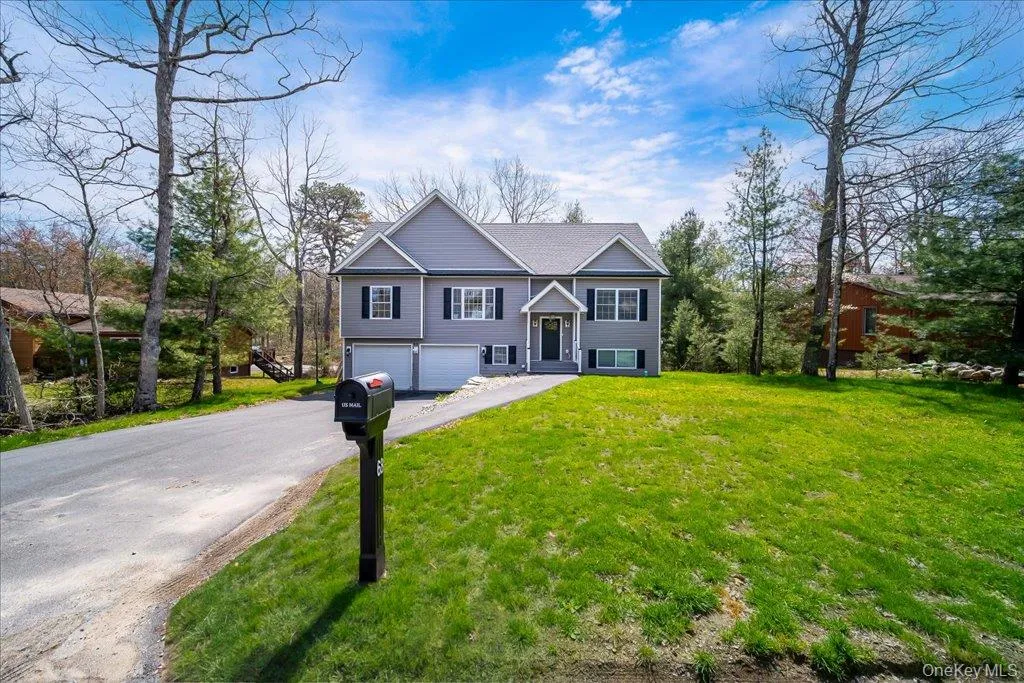 Contemporary two-story residence featuring gray siding and white trim Contemporary two-story residence featuring gray siding and white trim
