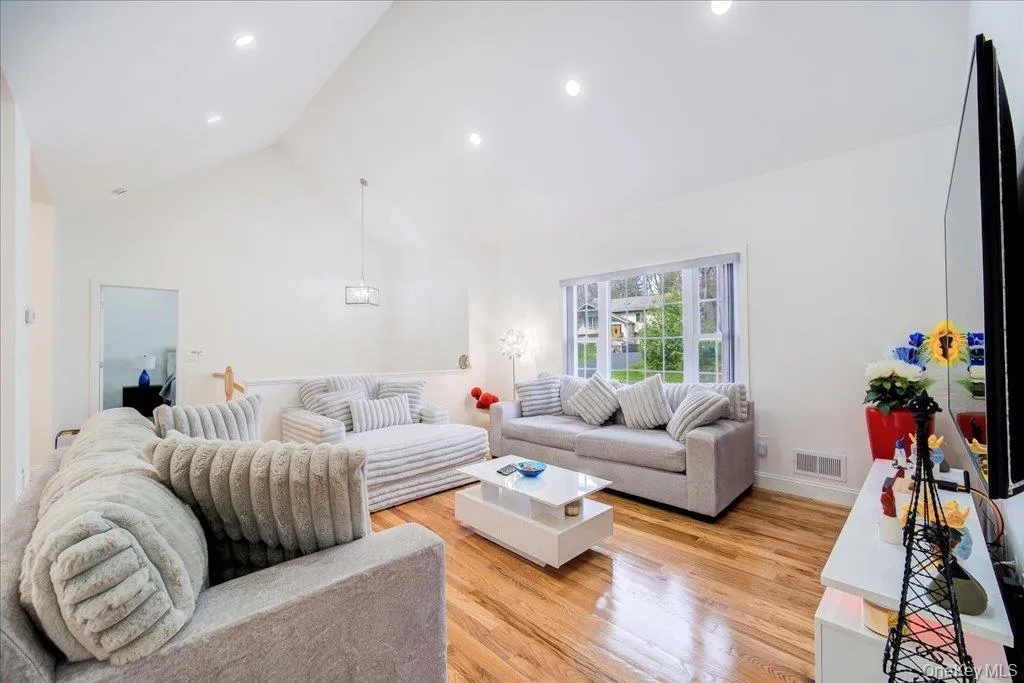 Living space featuring vaulted ceilings and recessed lighting Living space featuring vaulted ceilings and recessed lighting